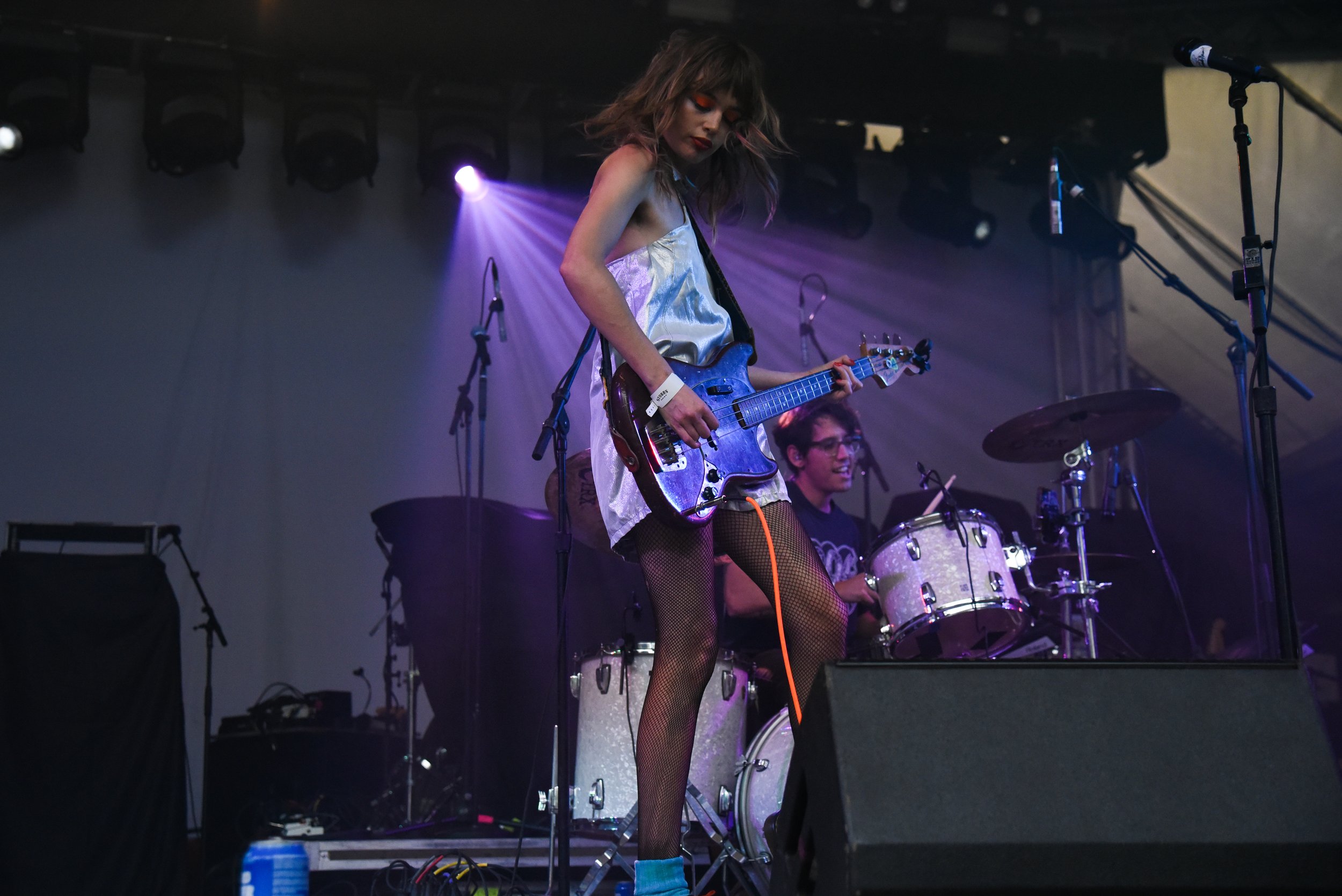  Staz Lindsy dances on stage while playing her guitar. 