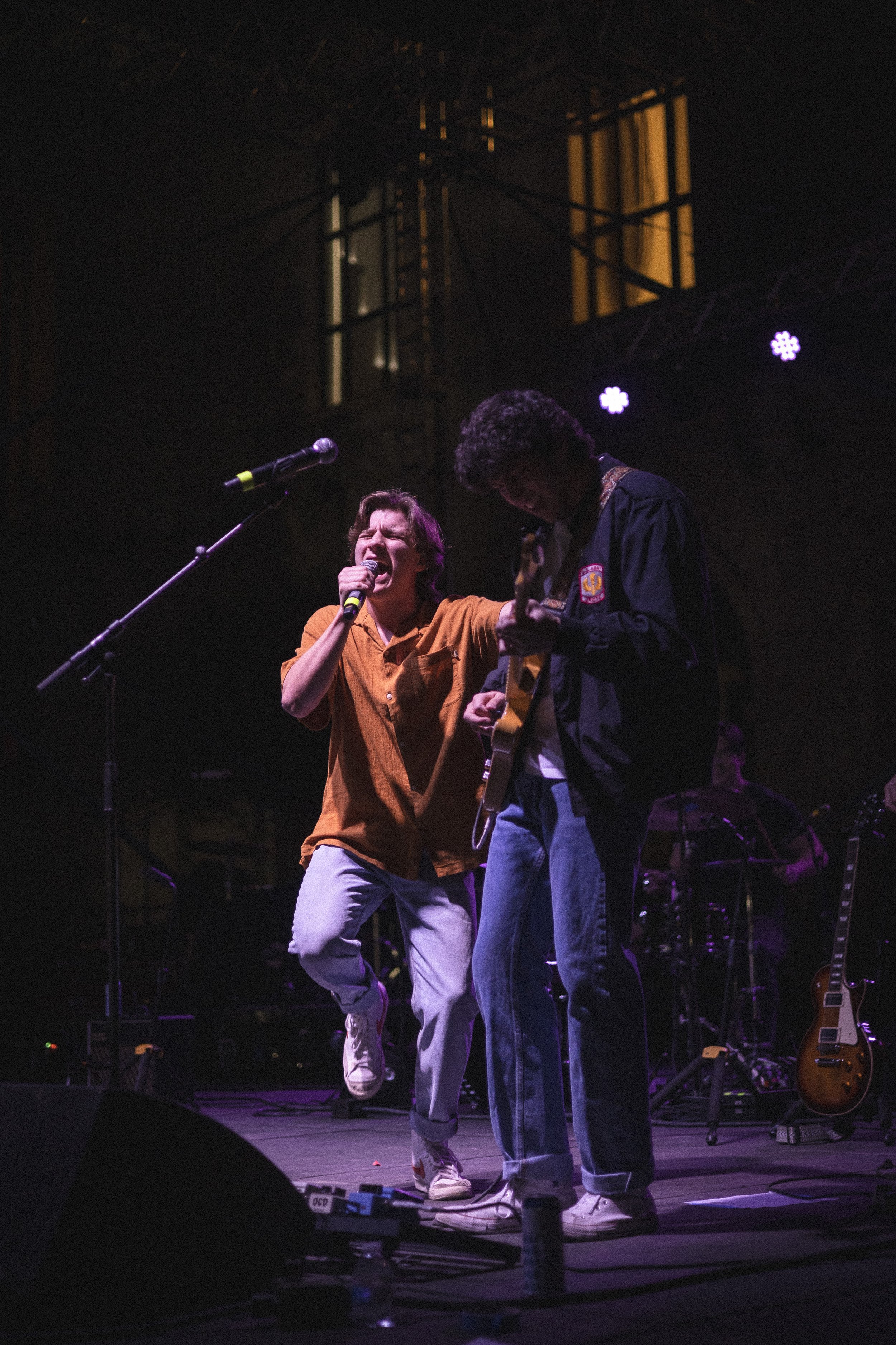  Logan Madsen, the lead singer of West 22nd, sings while interacting with his bandmates. 