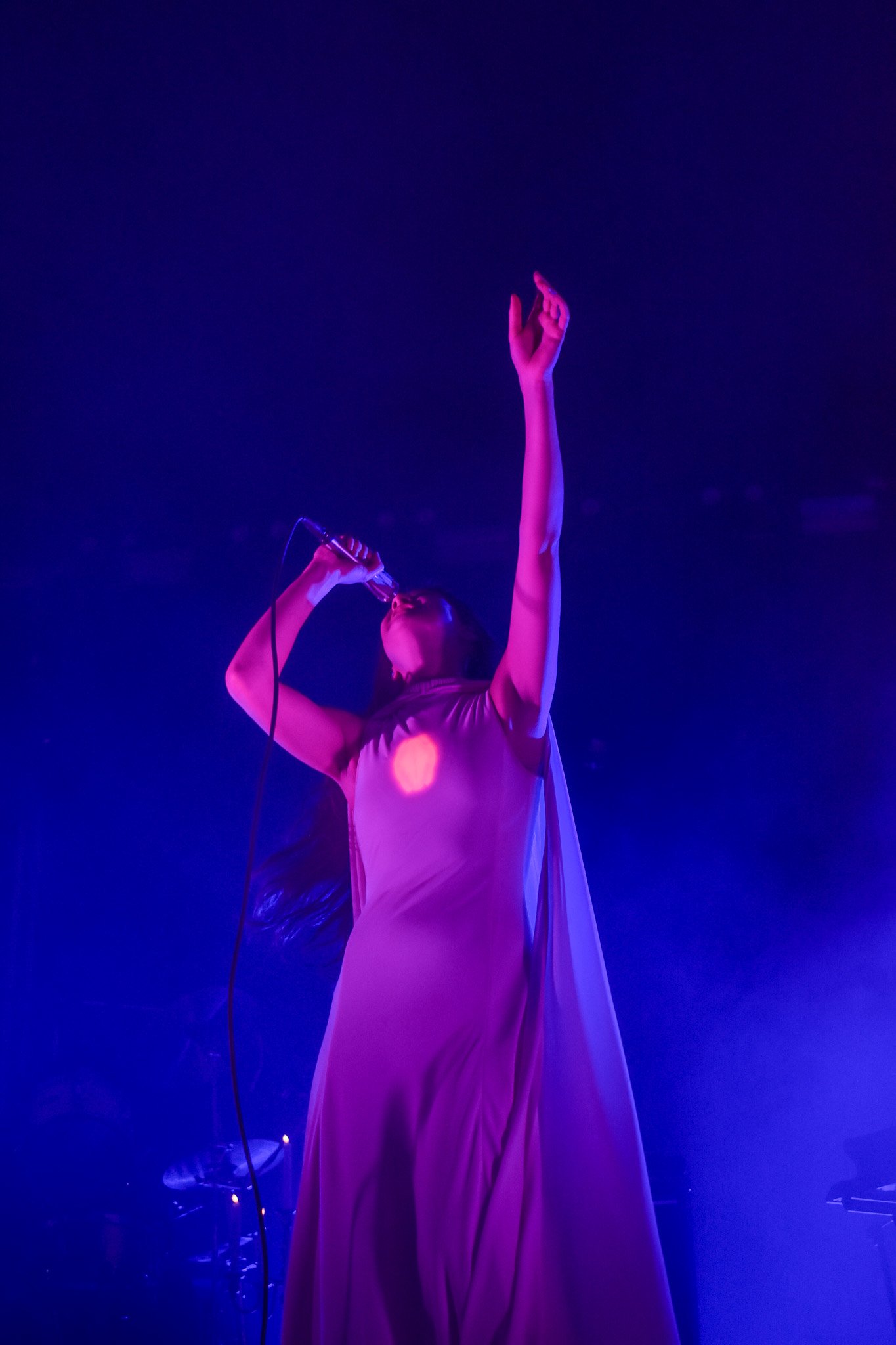  As Weyes Blood performs “Twin Flame,” she waves her cloak gracefully, revealing a glowing heart beneath her dress. 