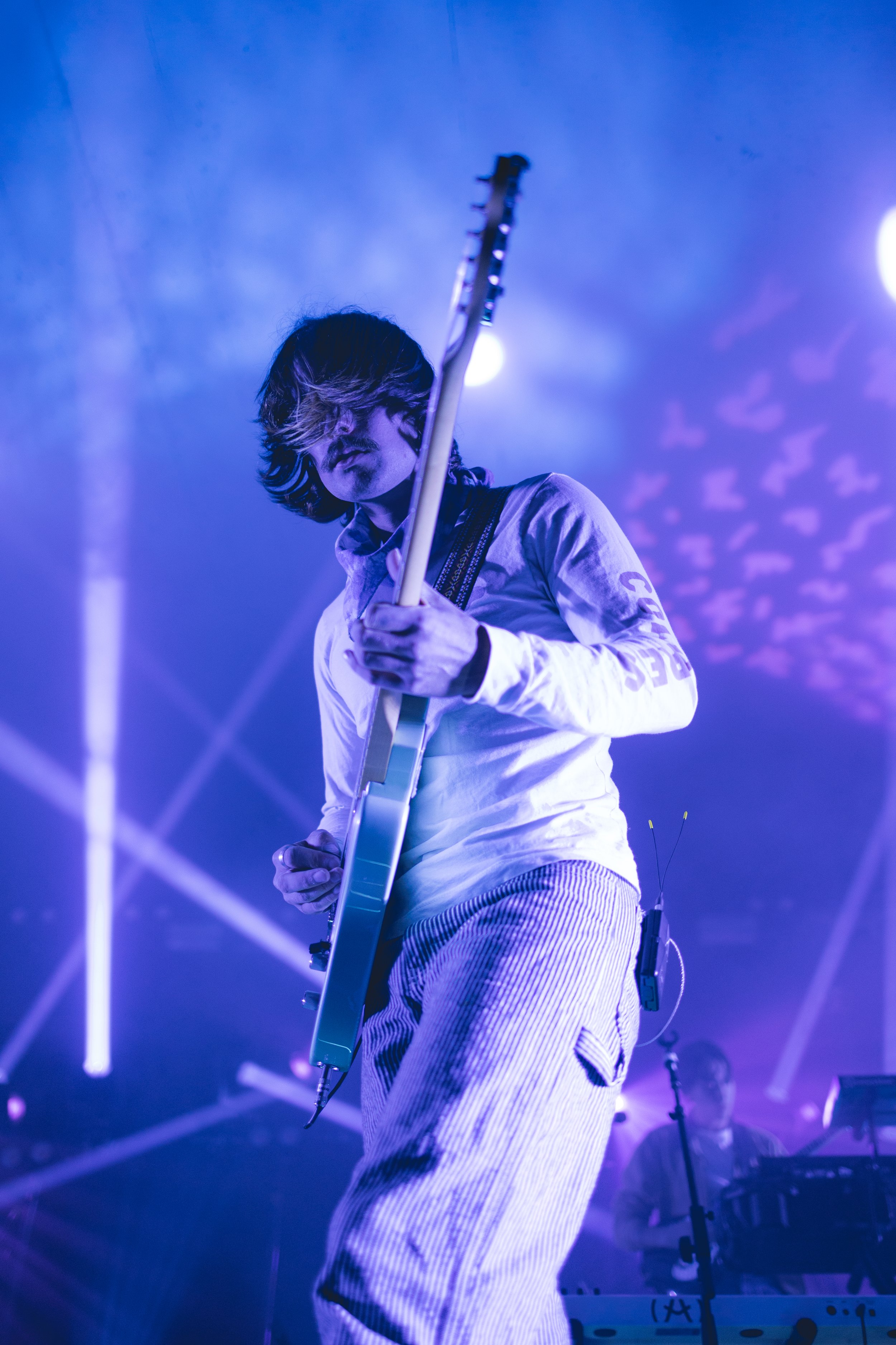  Griffin Washburn, the singer and instrumentalist of Goth Babe, adds dynamic to his vocal performance by strumming on the guitar. 