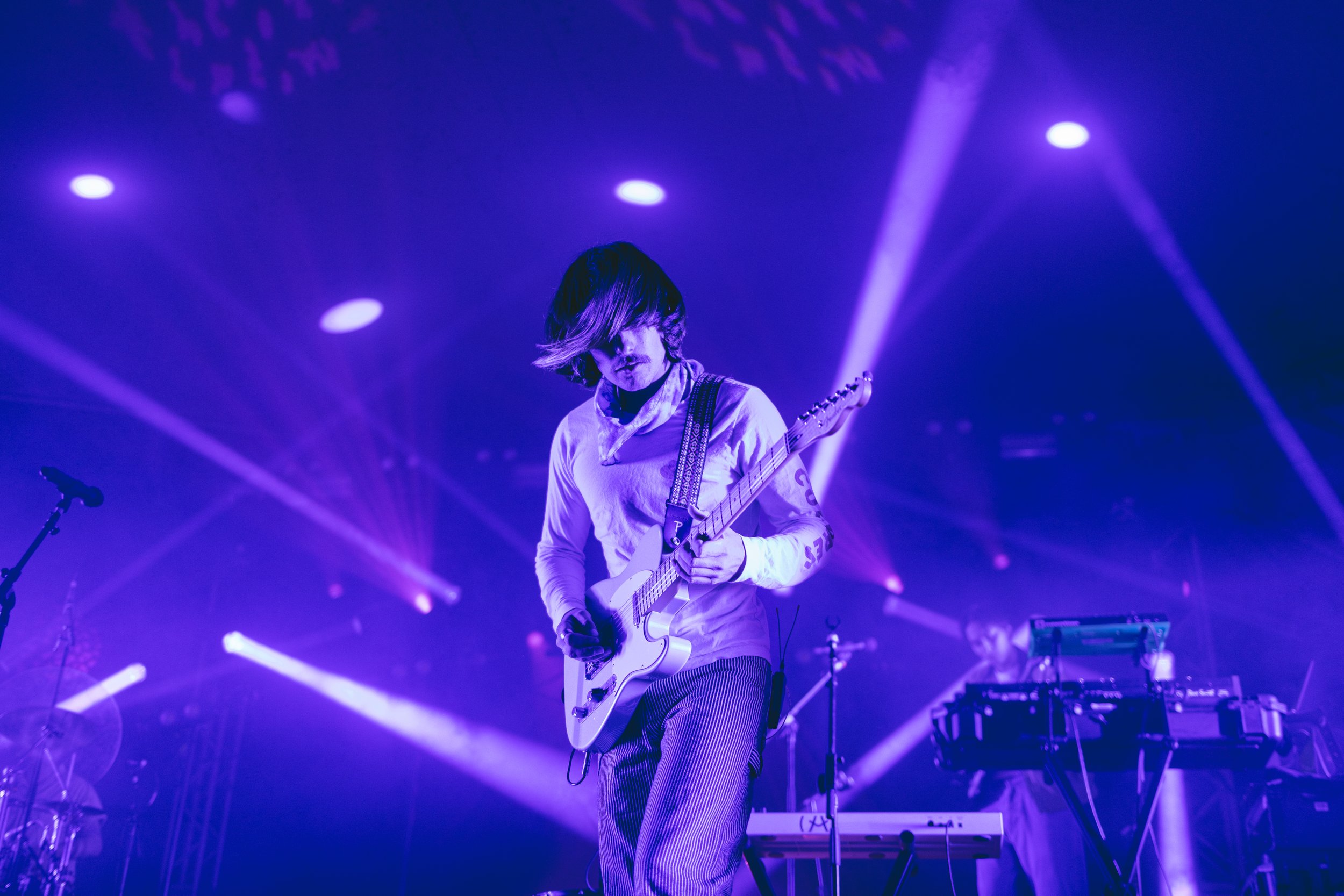  Griffin Washburn, the singer and instrumentalist of Goth Babe, adds dynamic to his vocal performance by strumming on the guitar. 