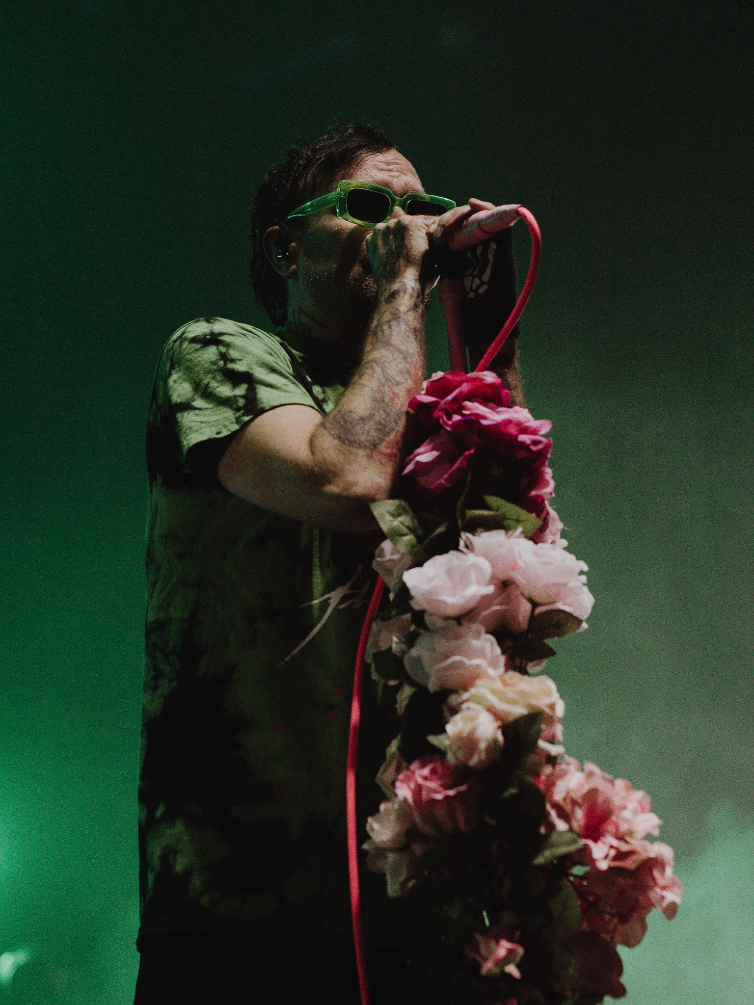 The Used frontman Bert McCracken owns the stage with his cornelia-covered mic stand.