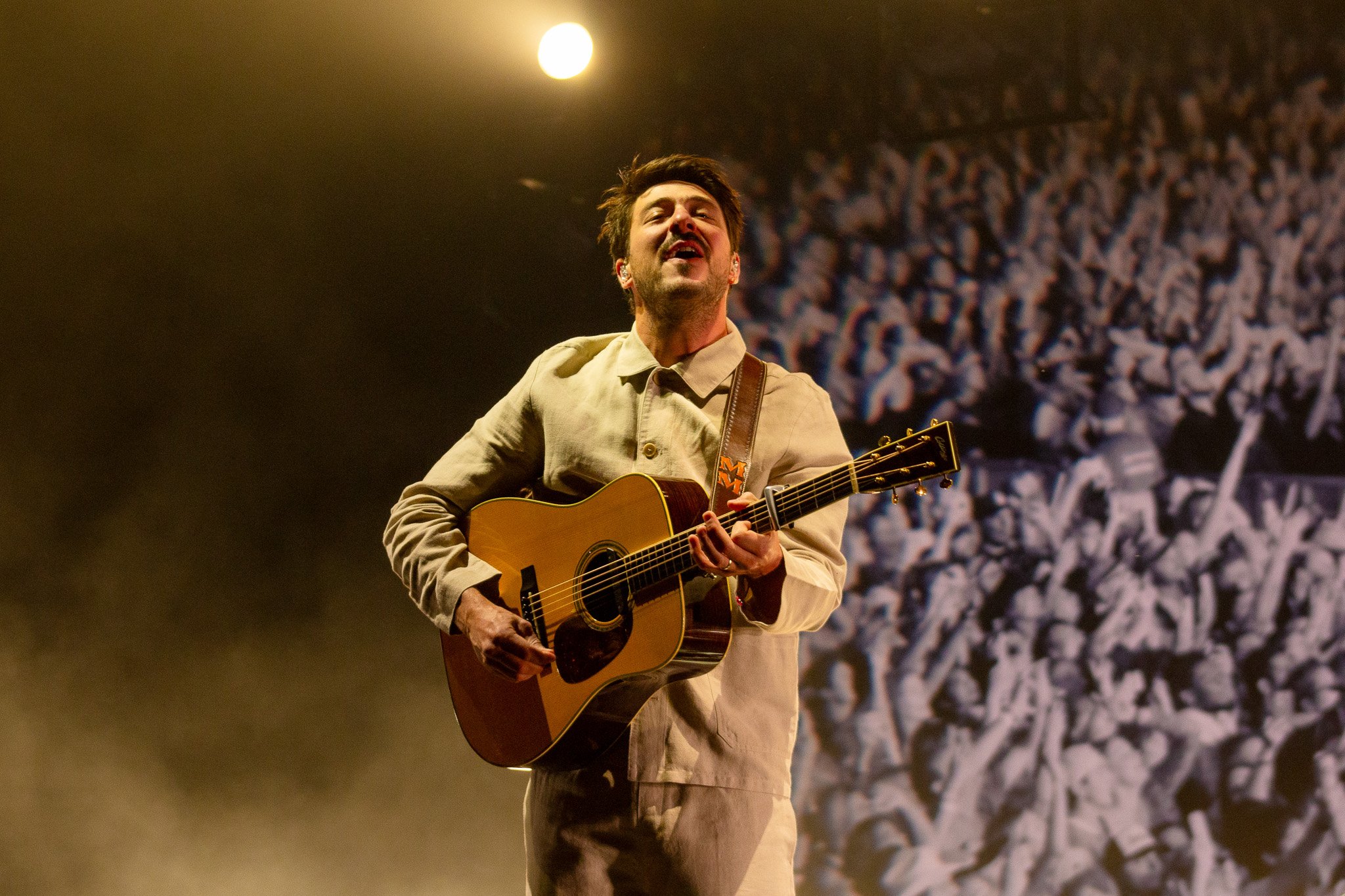  Marcus Mumford of Mumford &amp; Sons listens as the crowd sings along to “Little Lion Man.” 