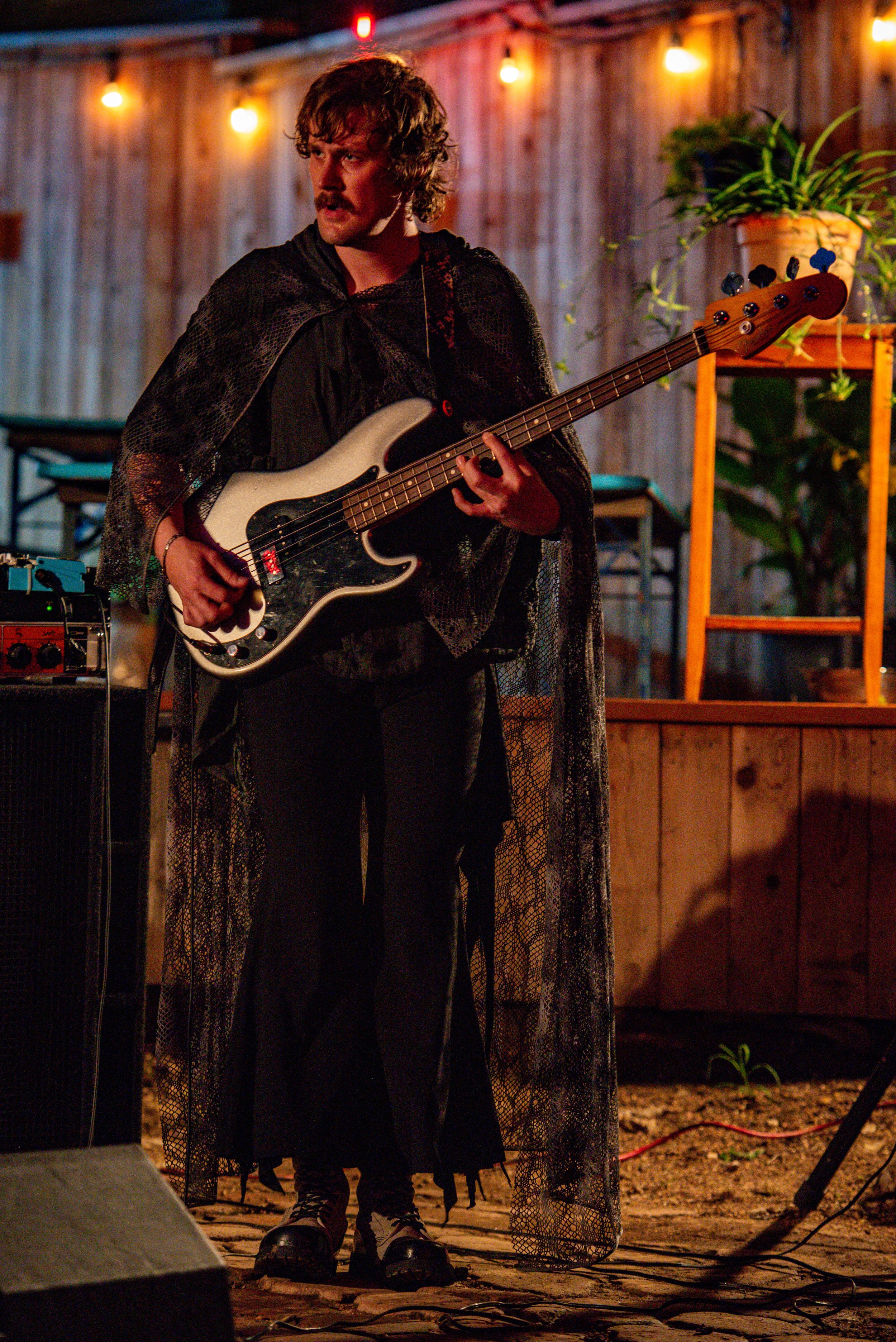  Dmitri’s bass player Lewis Grimes looks out toward the crowd.  Photo by Mackenzie Coleman  