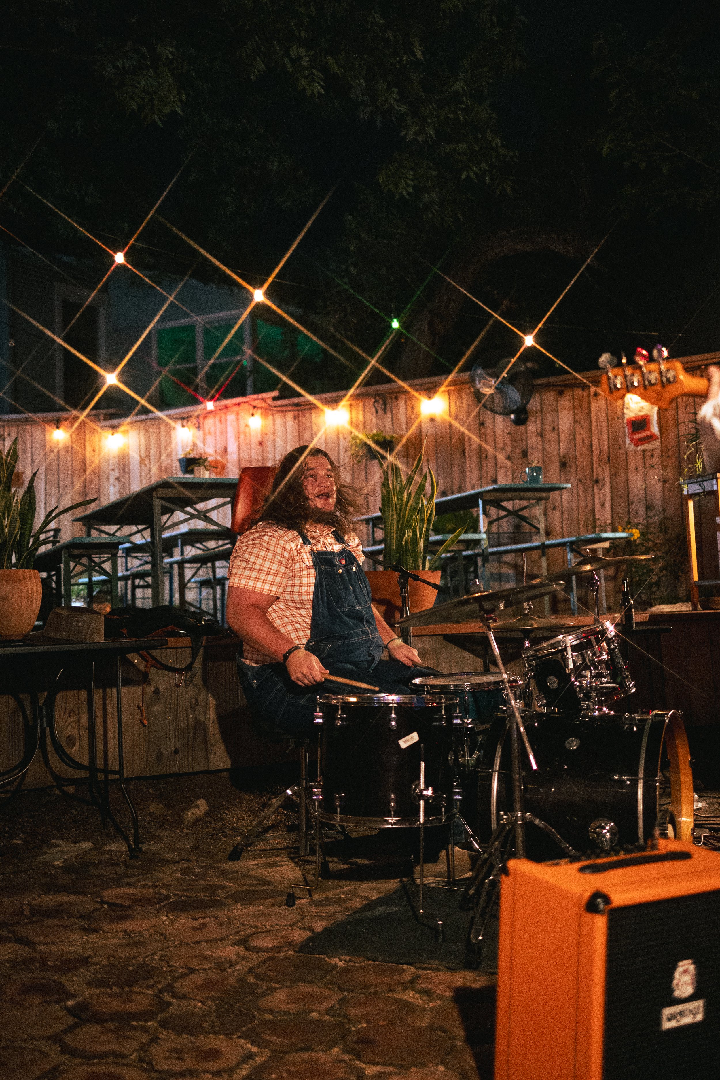  Charlie Stevens looks toward Joey Tea’s frontman after finishing an intense drum solo.  Photo by Amelia Tapia  