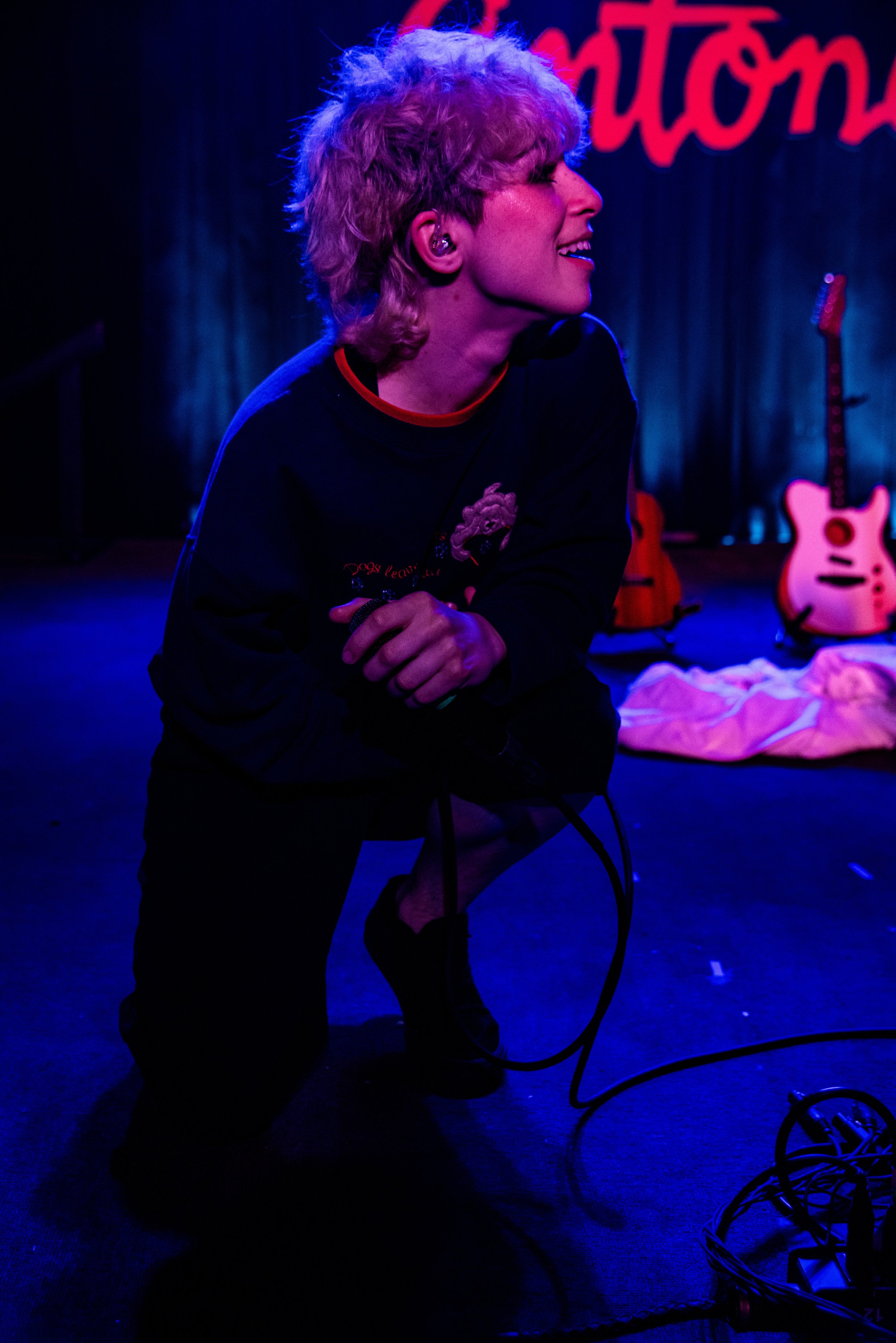  Leaning in close to the crowd, Addison Grace smiles as fans sing the lyrics to their song “Pessimistic.” 