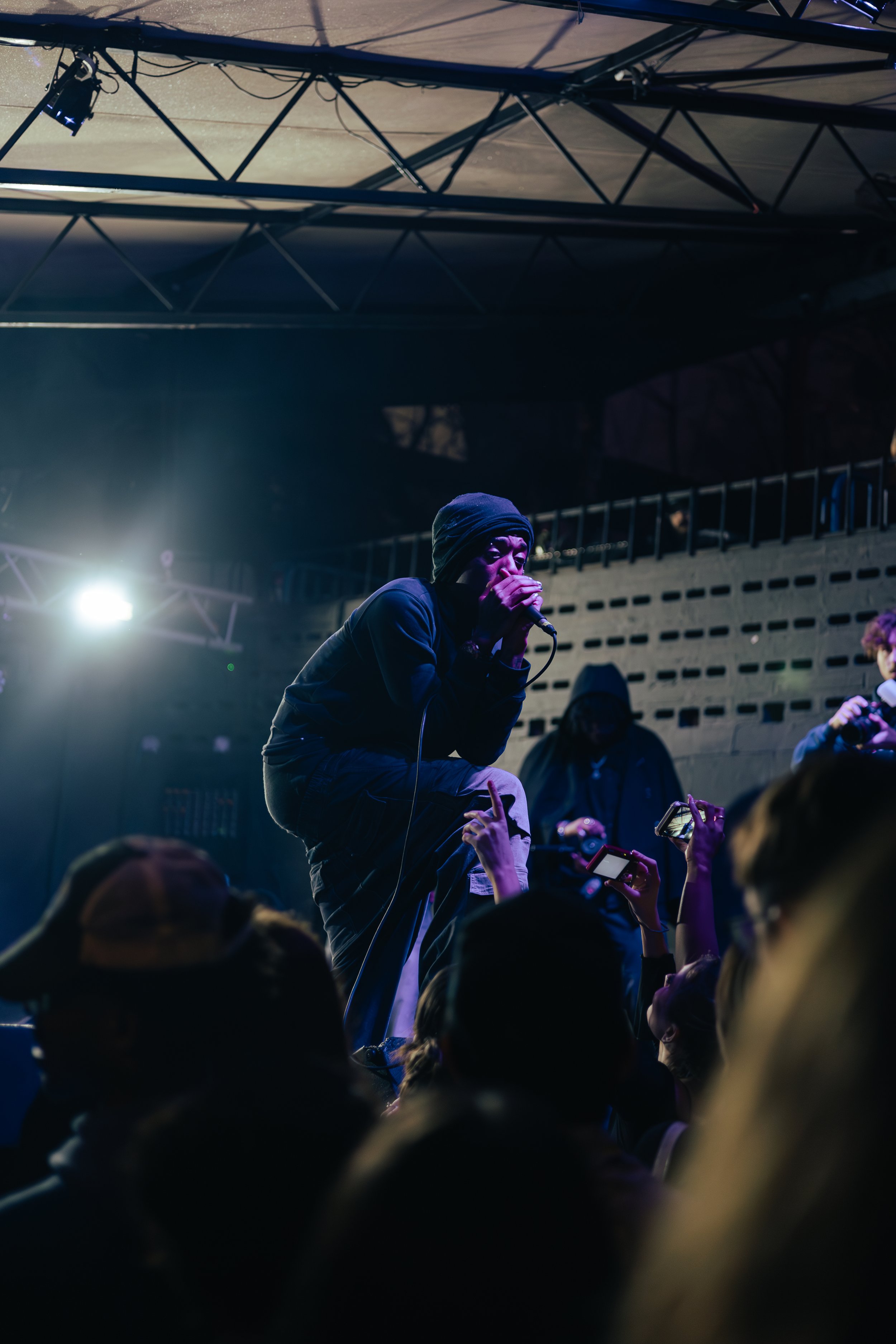 Tyler Brooks, the British rapper known as Skaiwater, looks out onto the moshing crowd. 