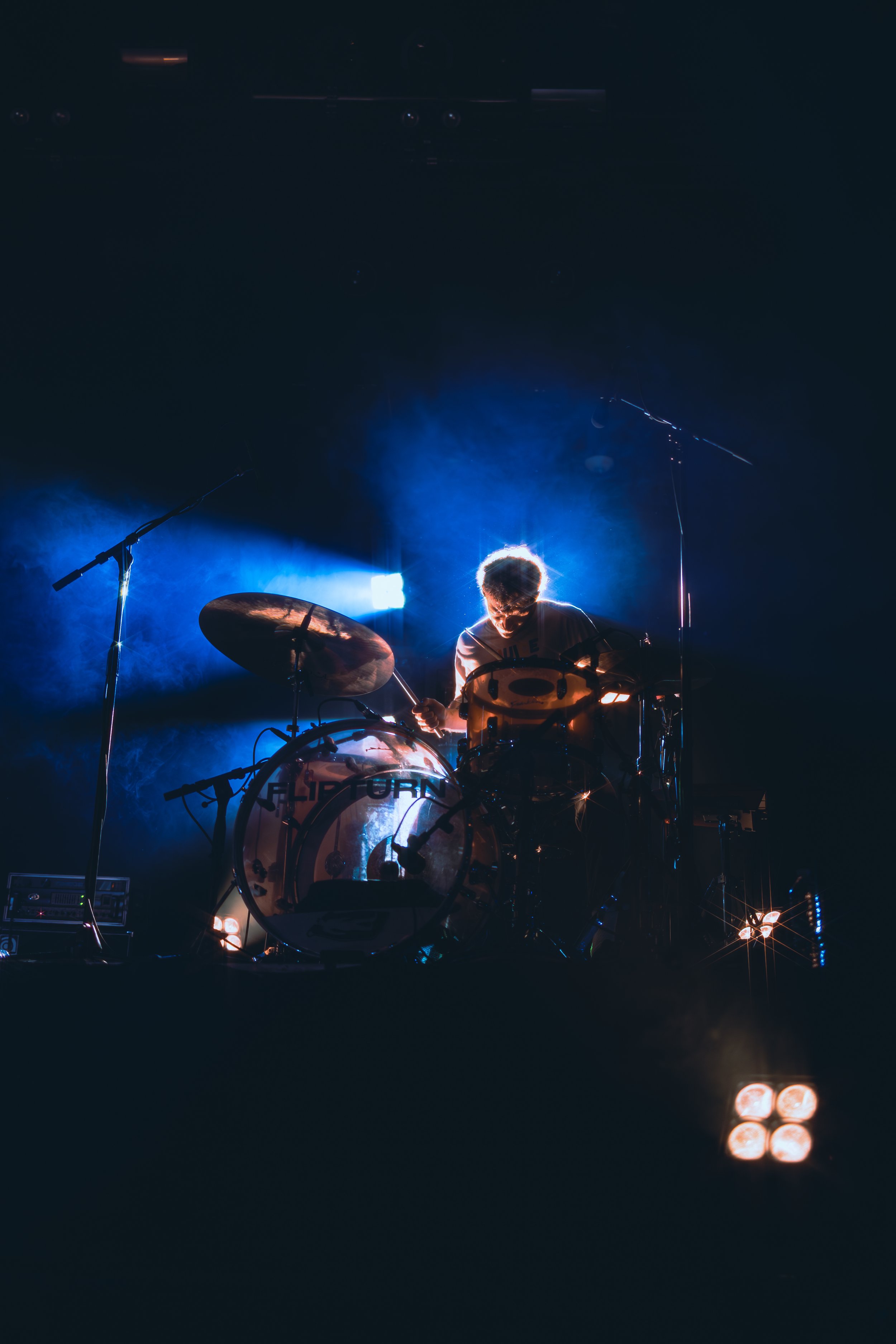  flipturn’s drummer, Devon VanBalson, rocks out under the flashing strobe lights. 