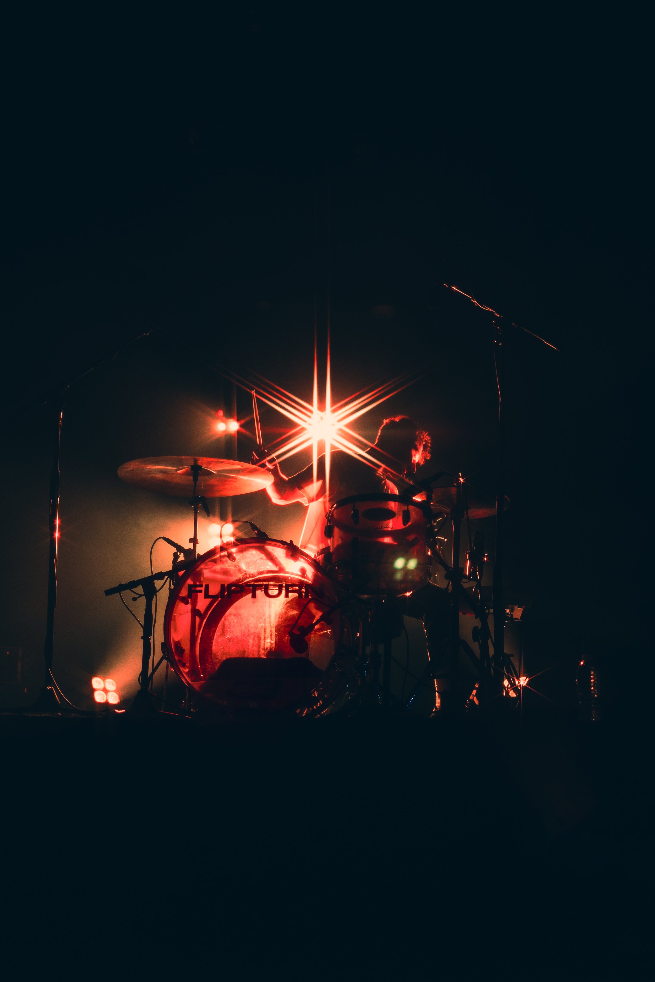  flipturn’s drummer, Devon VanBalson, rocks out under the flashing strobe lights. 