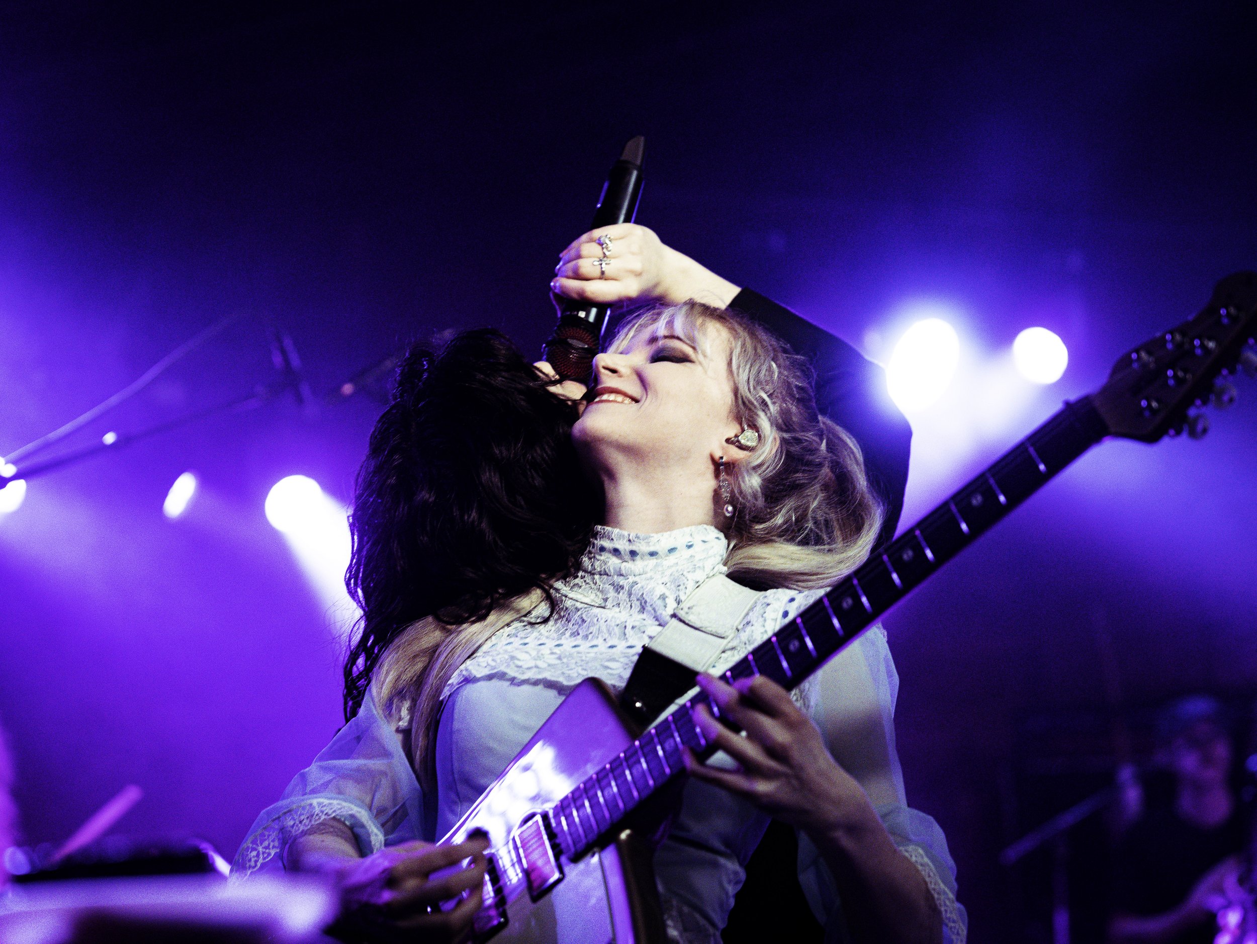  Abigail Morris, the lead singer of The Last Dinner Party, shares a moment of musical synergy with guitarist Emily Roberts. 