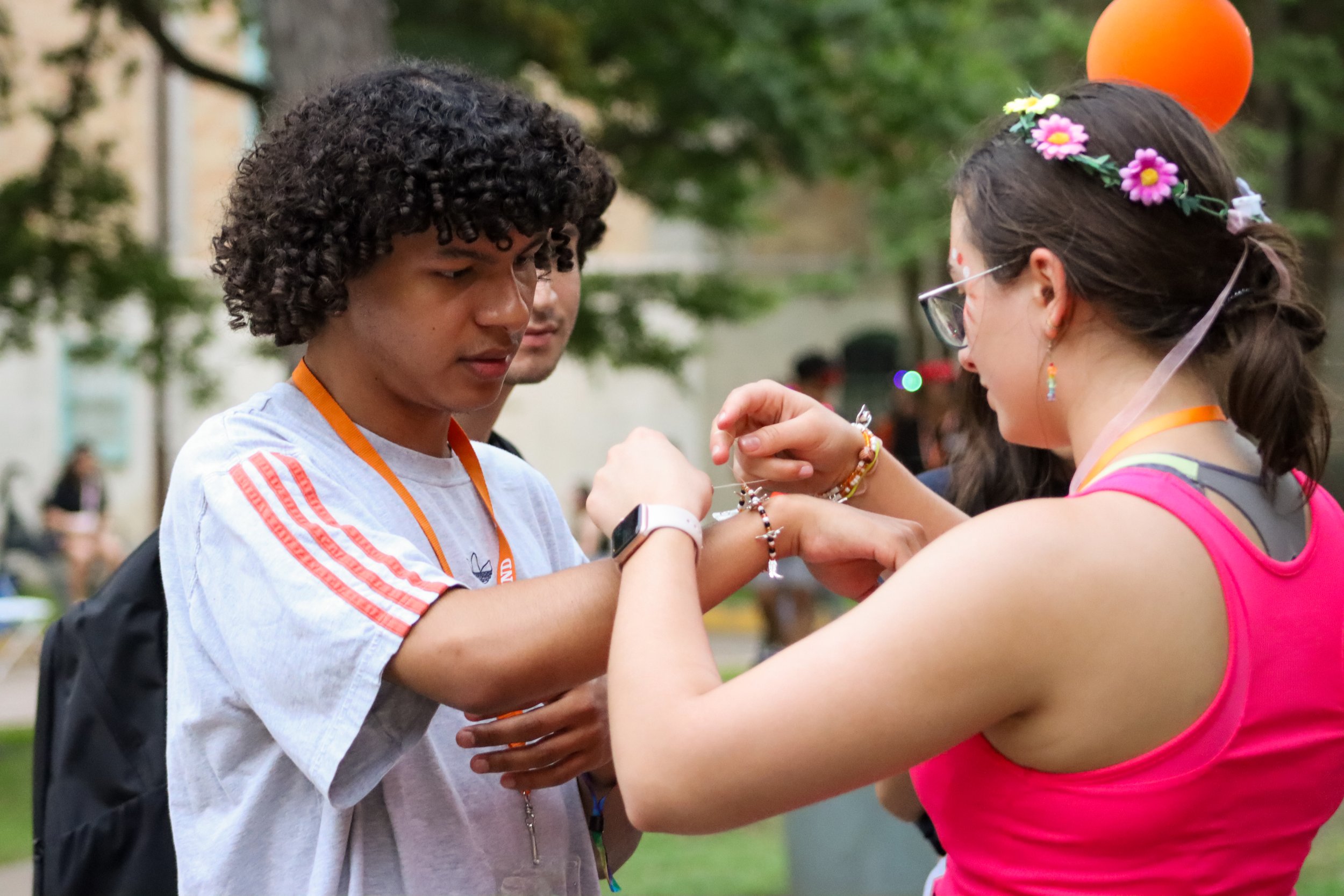  A student receives a handmade bracelet with longhorn and boot charms.&nbsp; 
