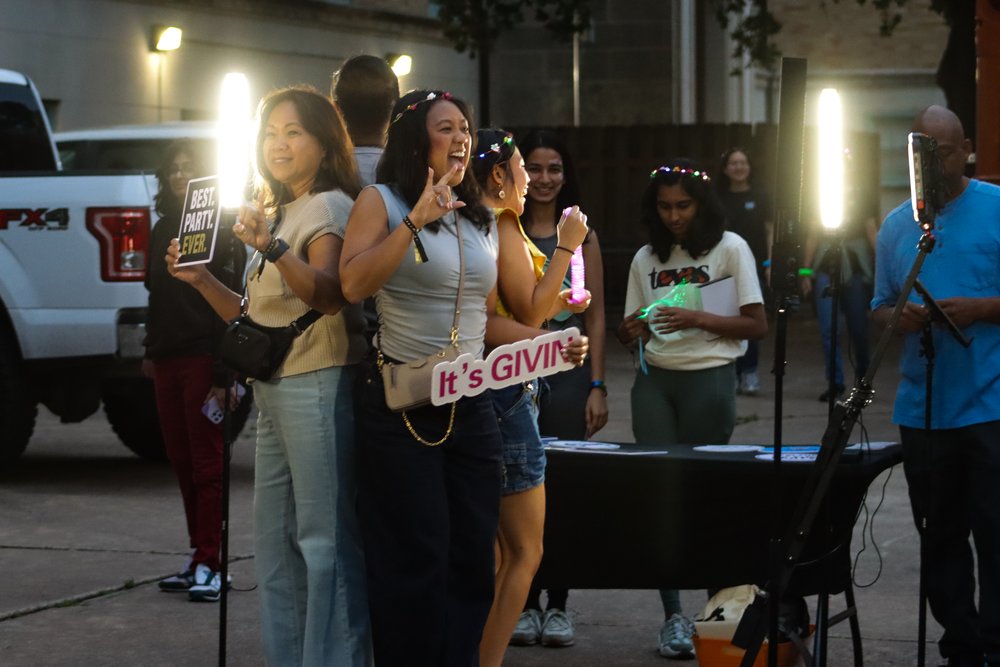  A family takes a picture using the spinning selfie booth. 