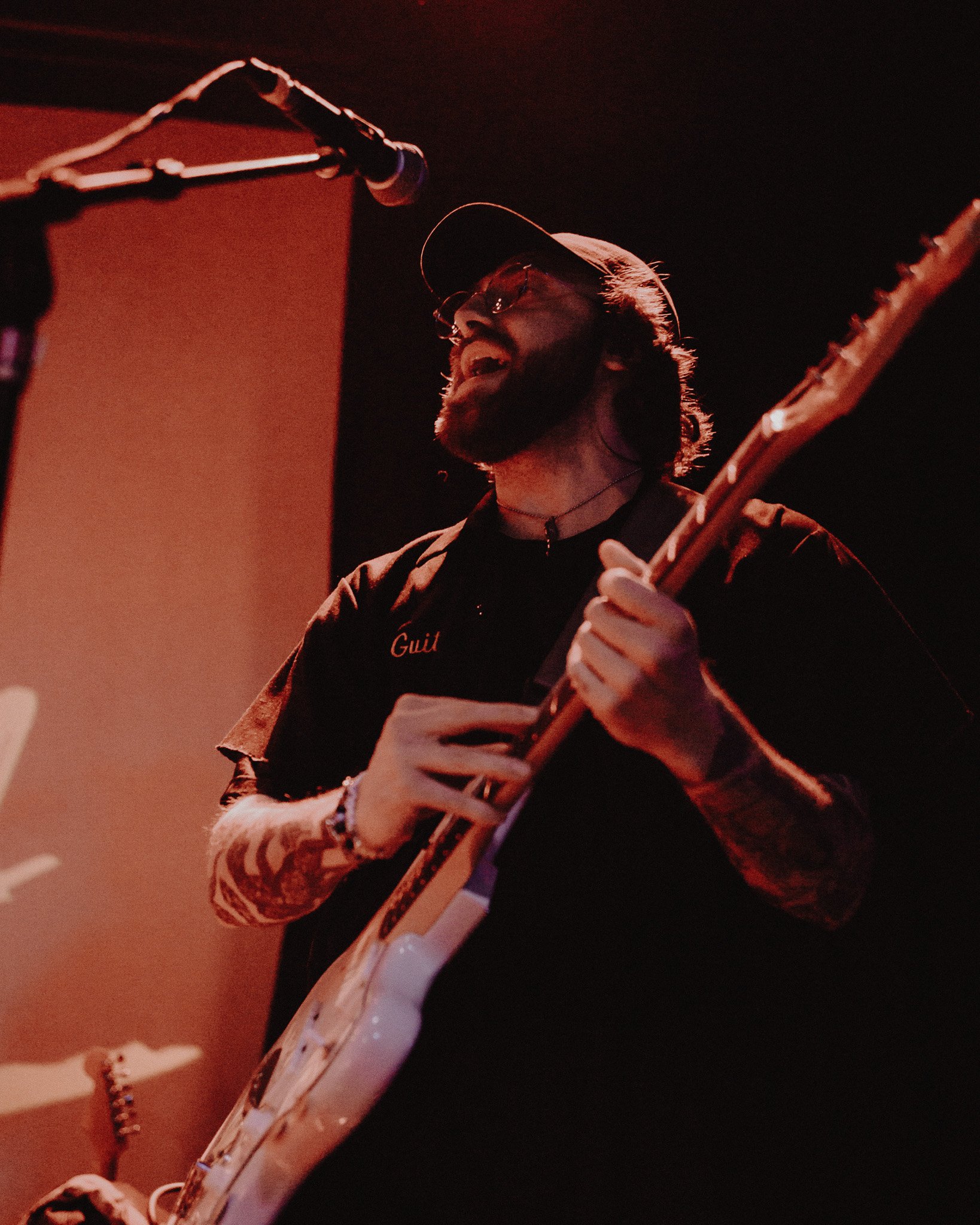  Sweet Pill member Sean McCall beams as he plays his guitar. 