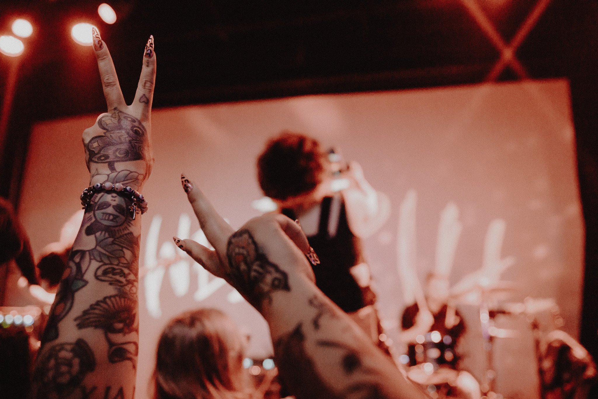  Fans hold up peace signs as Youssef takes a photo on a fan’s phone. 