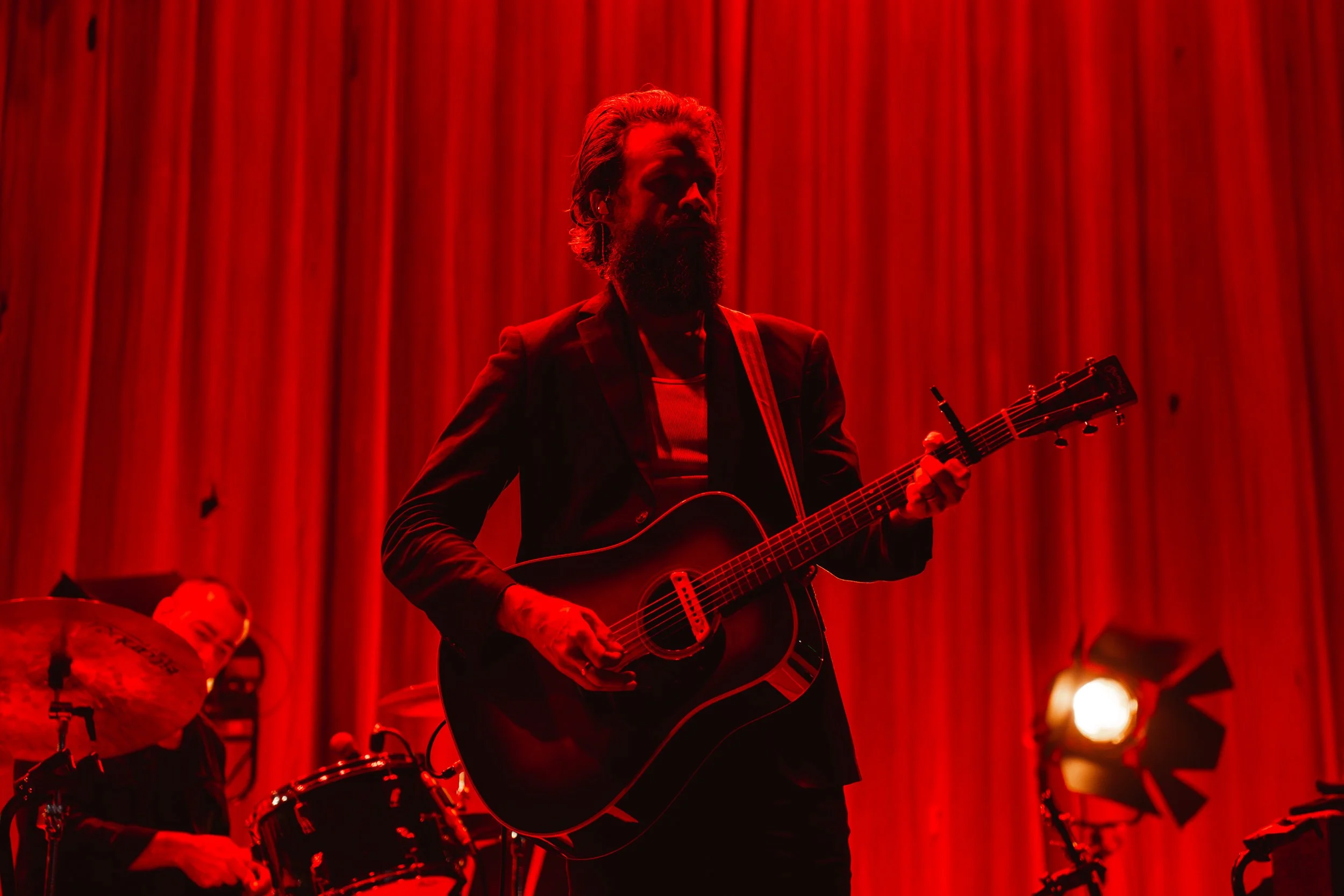 Father John Misty takes the stage with an acoustic guitar and band, playing “I Guess Time Just Makes Fools Of Us All.”