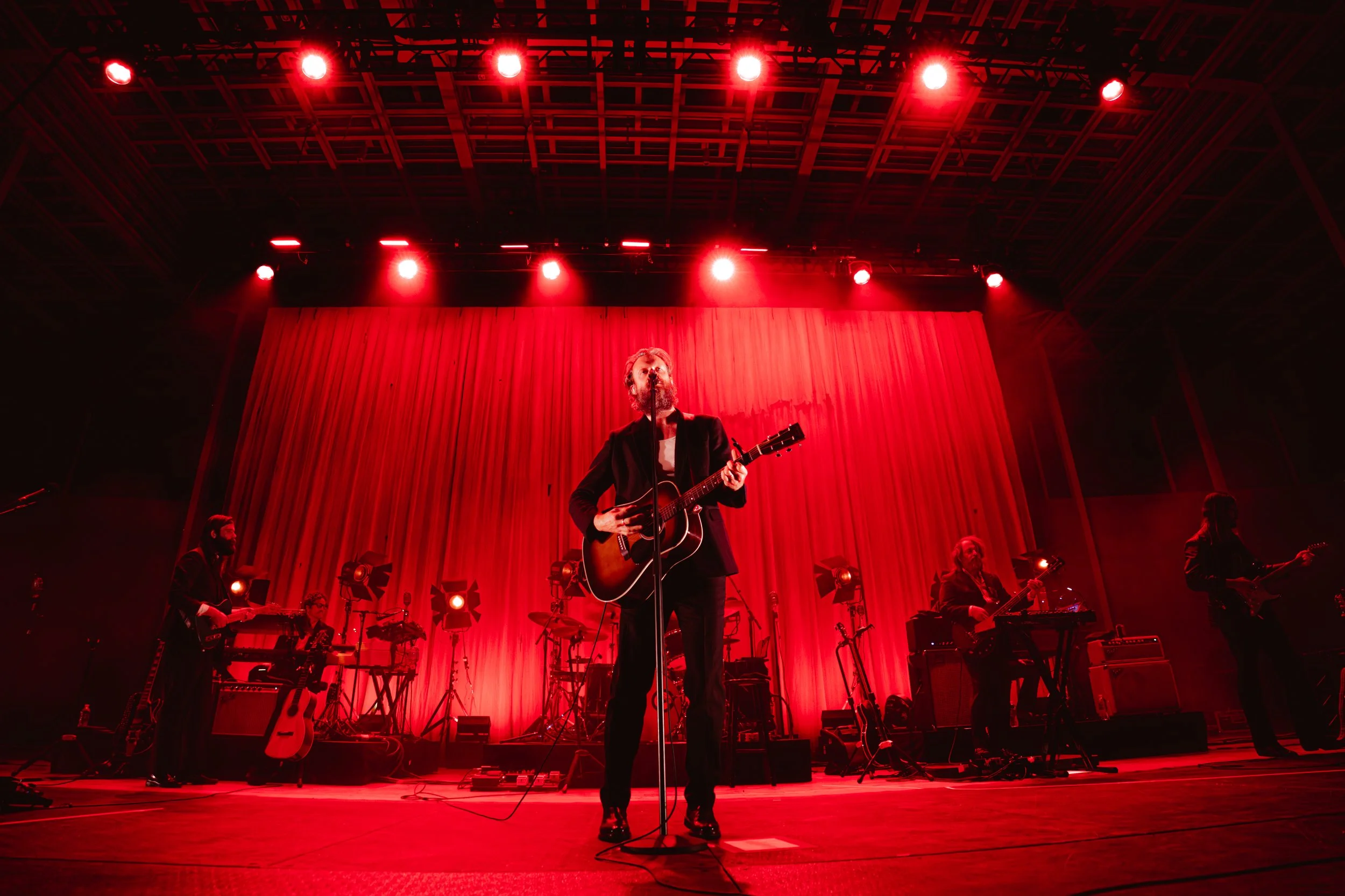 Father John Misty takes the stage with an acoustic guitar and band, playing “I Guess Time Just Makes Fools Of Us All.”