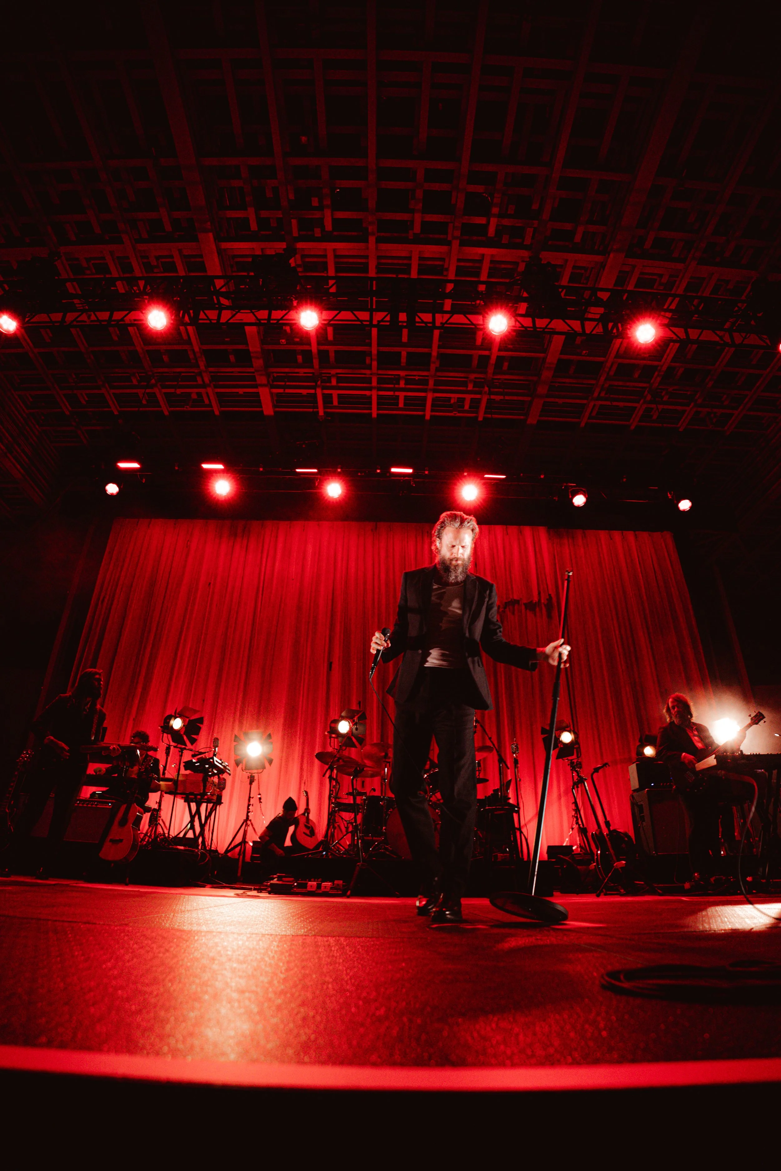 Abandoning the guitar, Father John Misty dances as he sings the lyrics to his opening song: “Most of us old men die at the firing line / Just waiting for our number to be called / I guess time just makes fools of us all.”