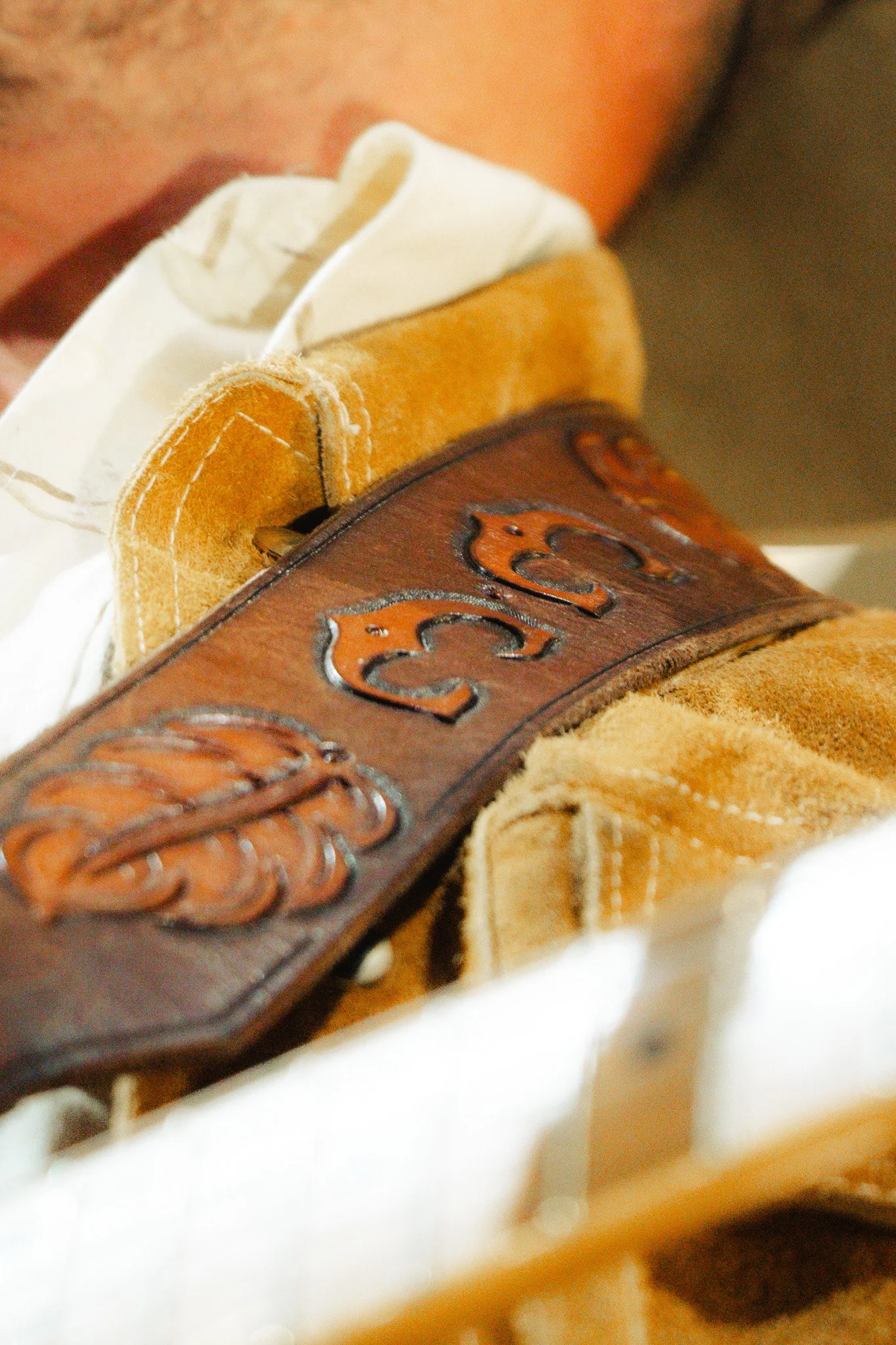 Charley Crockett wears a custom leather guitar strap for the show.
