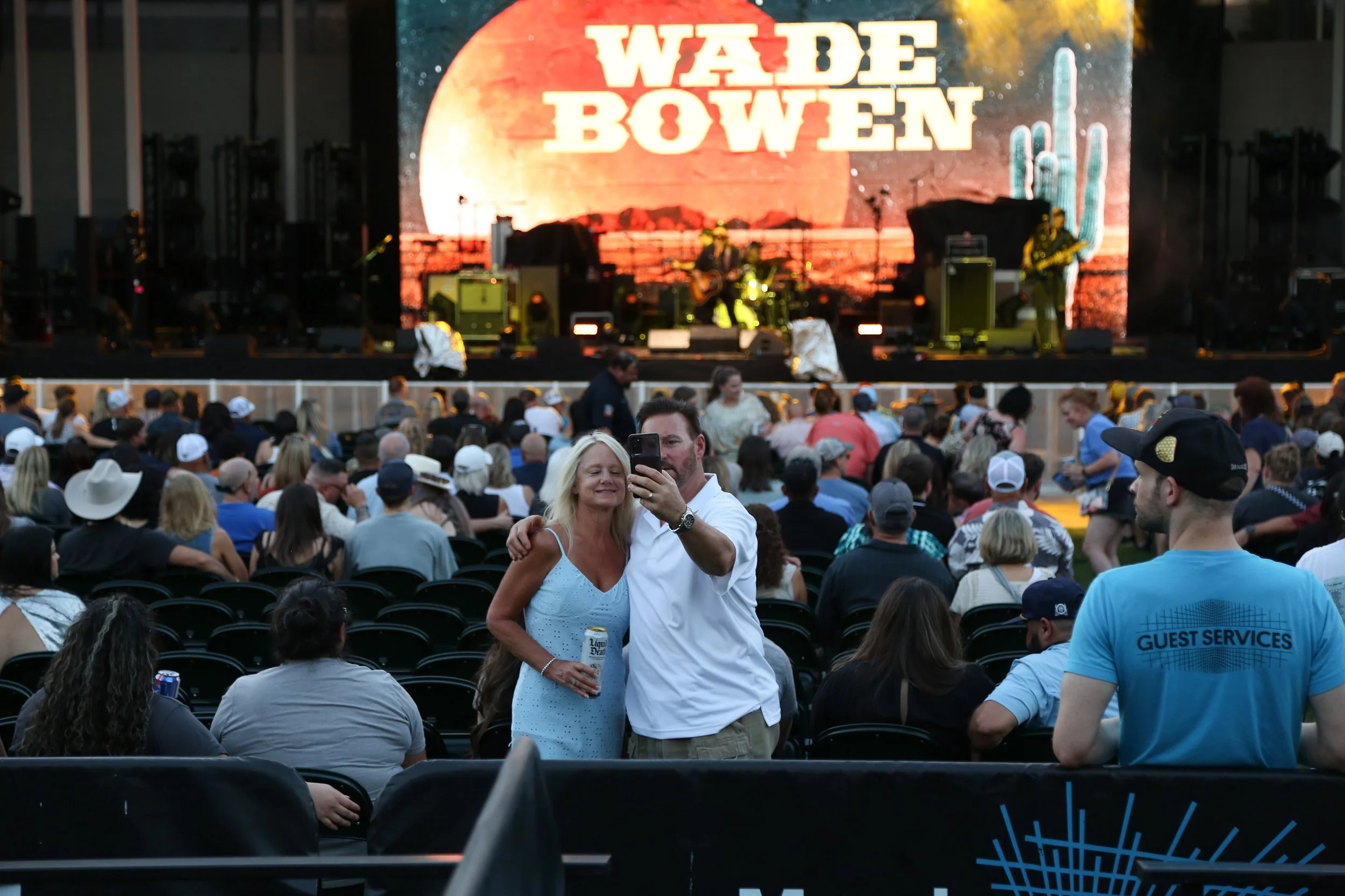 Fans capture a moment together while Wade Bowen sings the lyrics to his opening song: “I wish trouble always looked that good.”