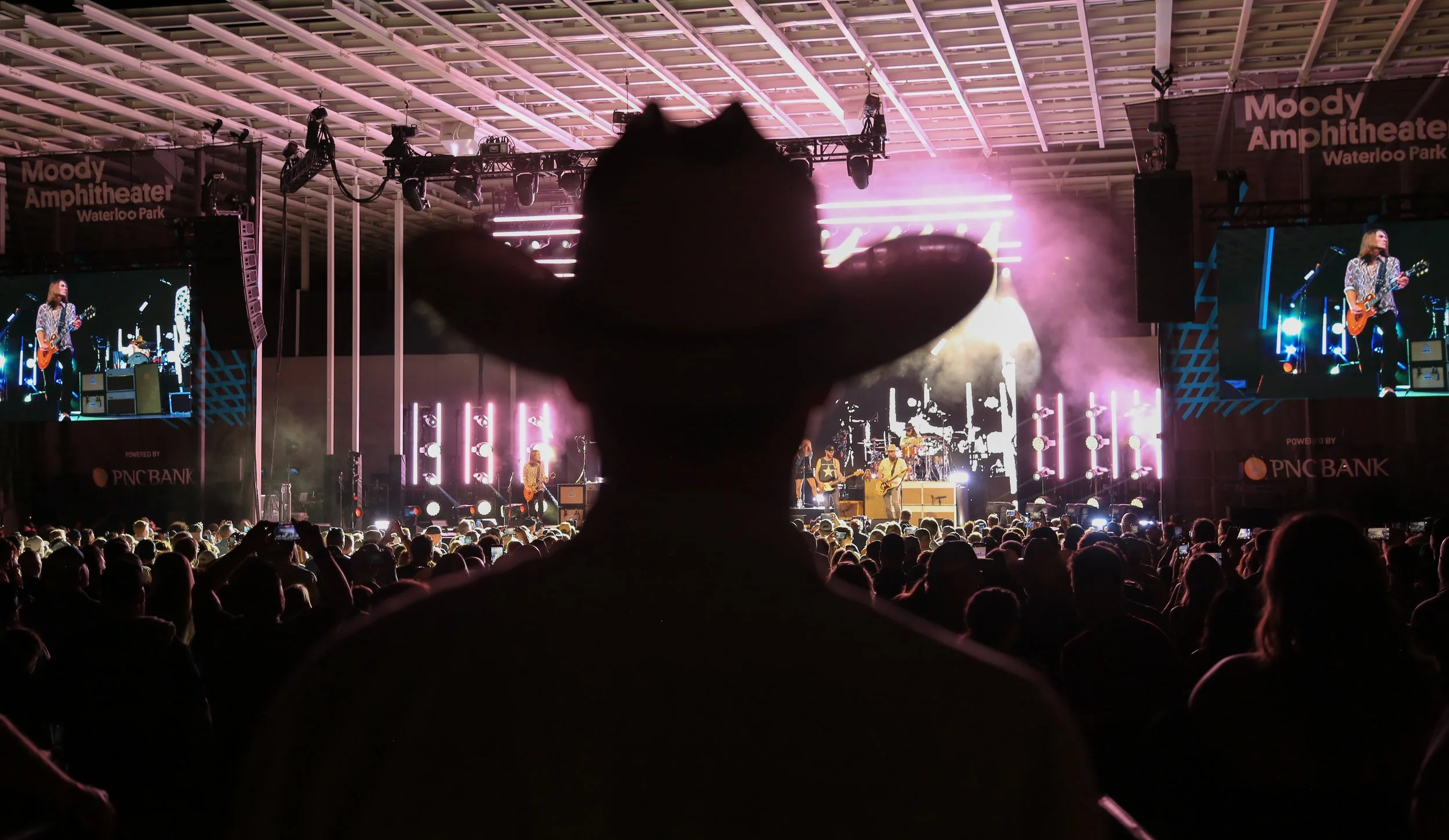 A fan wearing a cowboy hat watches Whiskey Myers perform "Gasoline.”