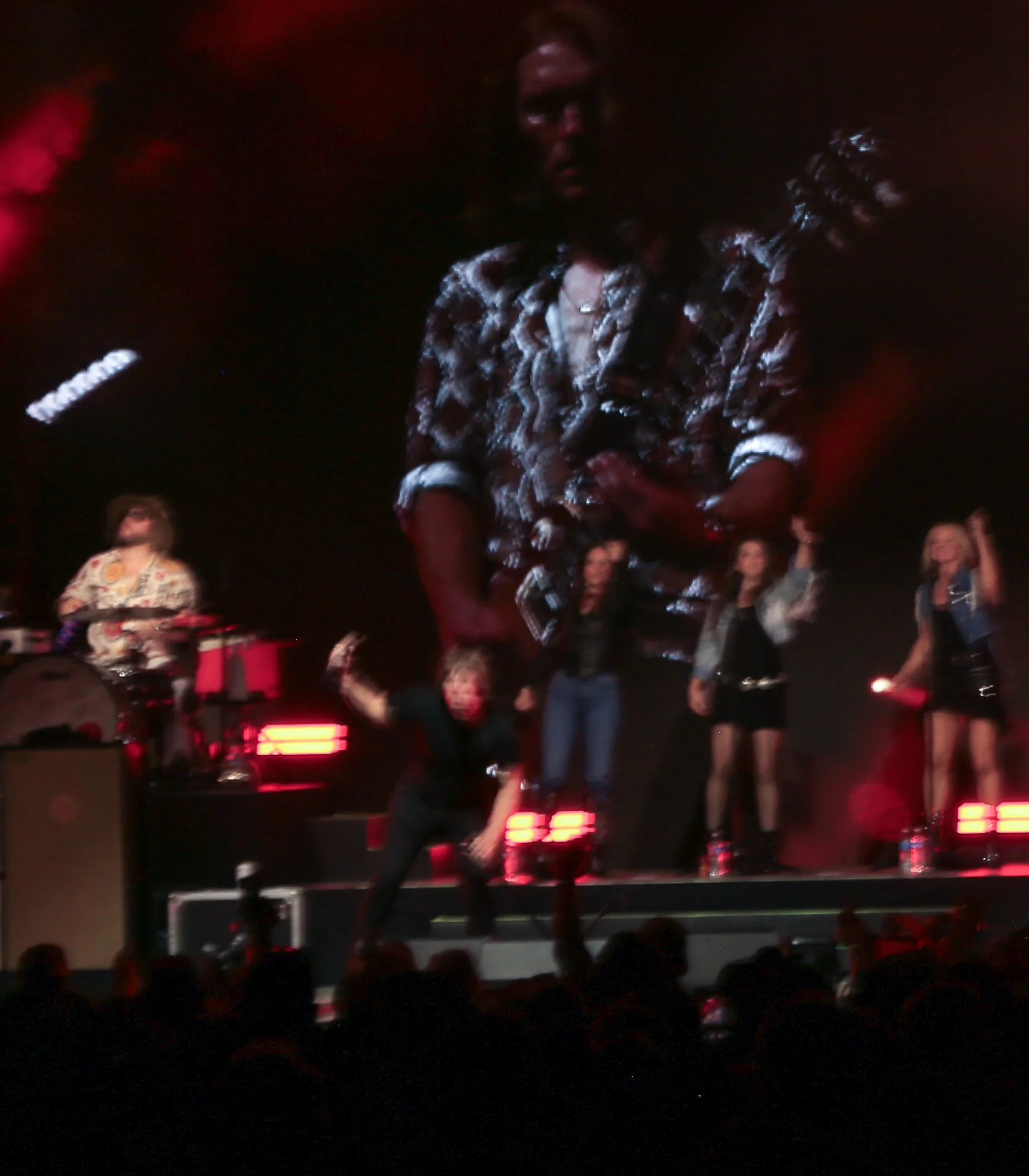 Canon points the microphone towards the crowd while they sing the lyrics to “Frogman.”