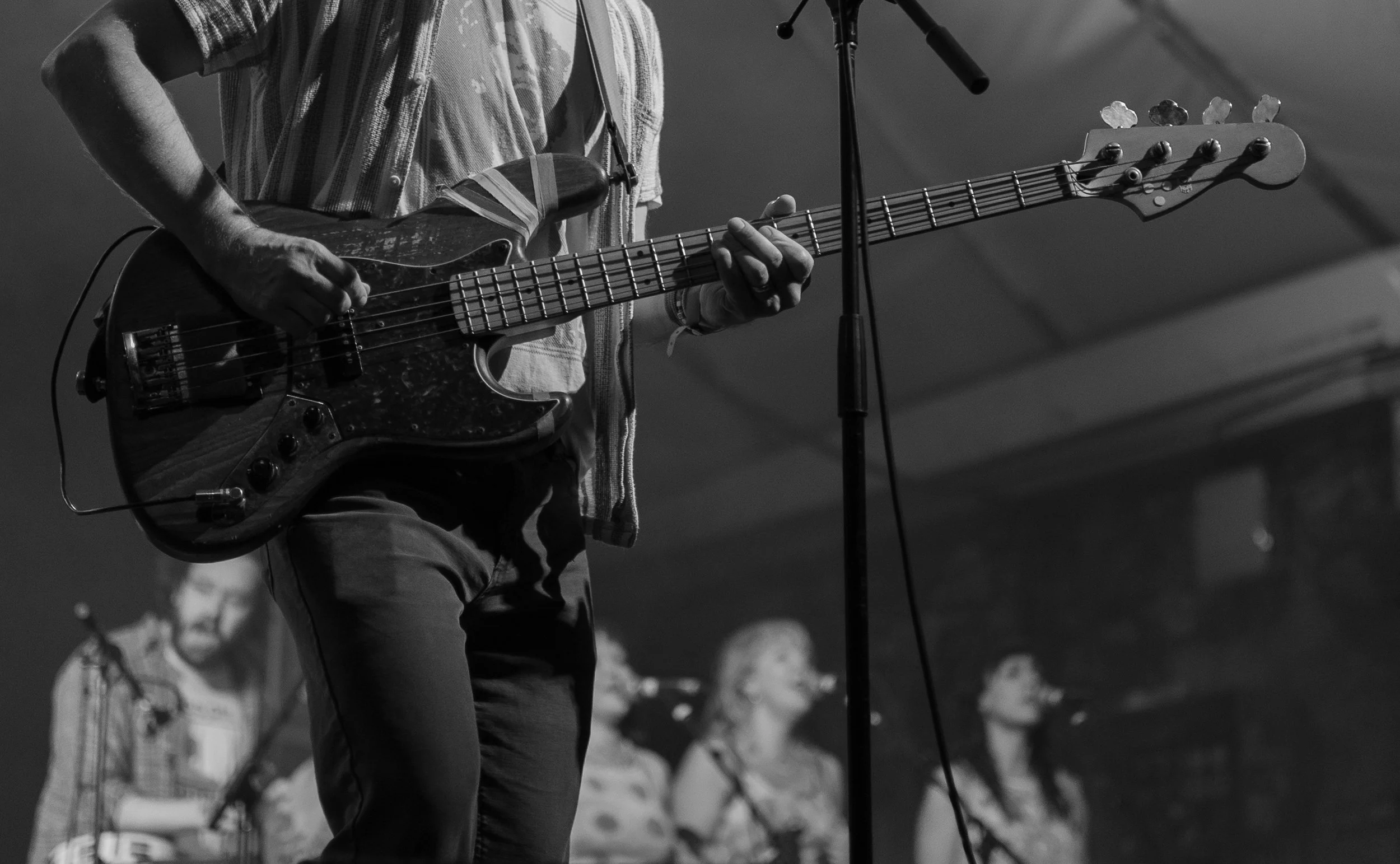 Leaman effortlessly controls the bass while the audience sings along to “Talk is Cheap.”