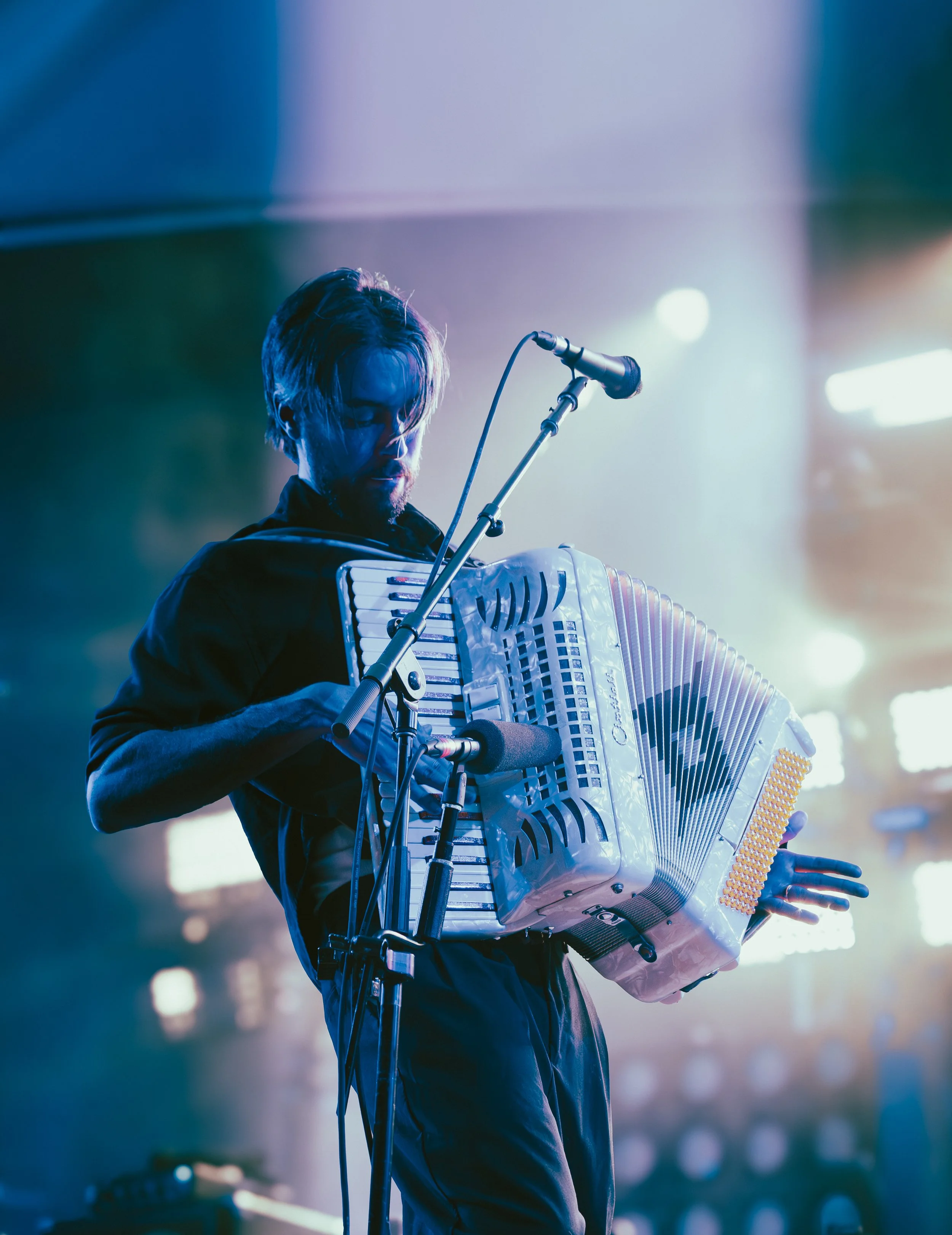 Alex G performs “June Guitar” from his 2025 album Headlights while pressing the keys on his glossy accordion.