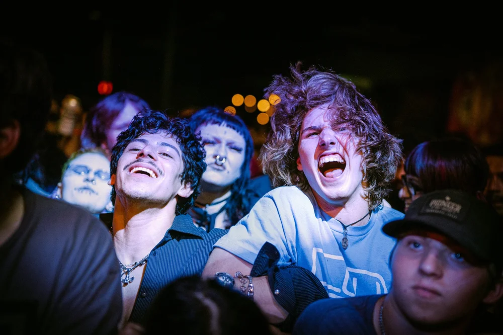  Energized fans headbang along to the aggressive beat of protest song “Why.” 