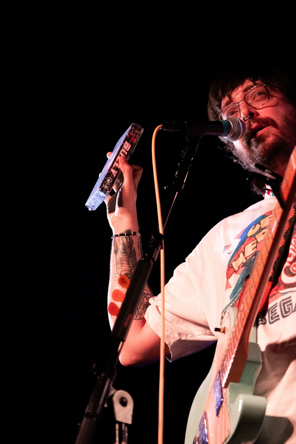  Austin Durry shows the crowd the prize for DURRY’s mid-concert giveaway, a rare VHS tape made for its new album. 