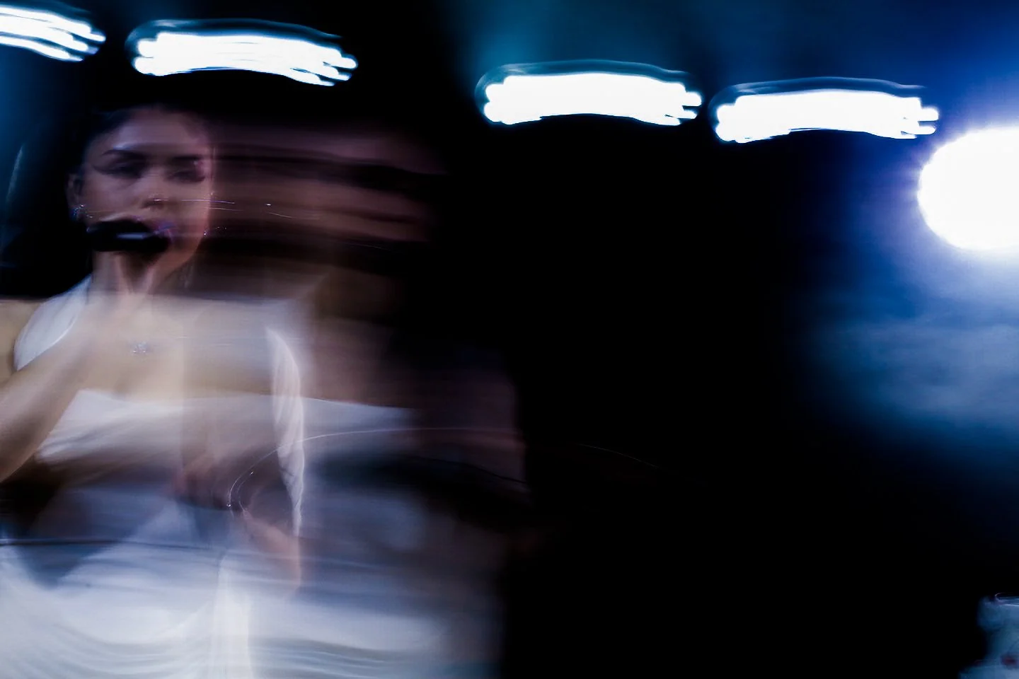  Gates dances in front of a single white three-tier cake, her only prop. 