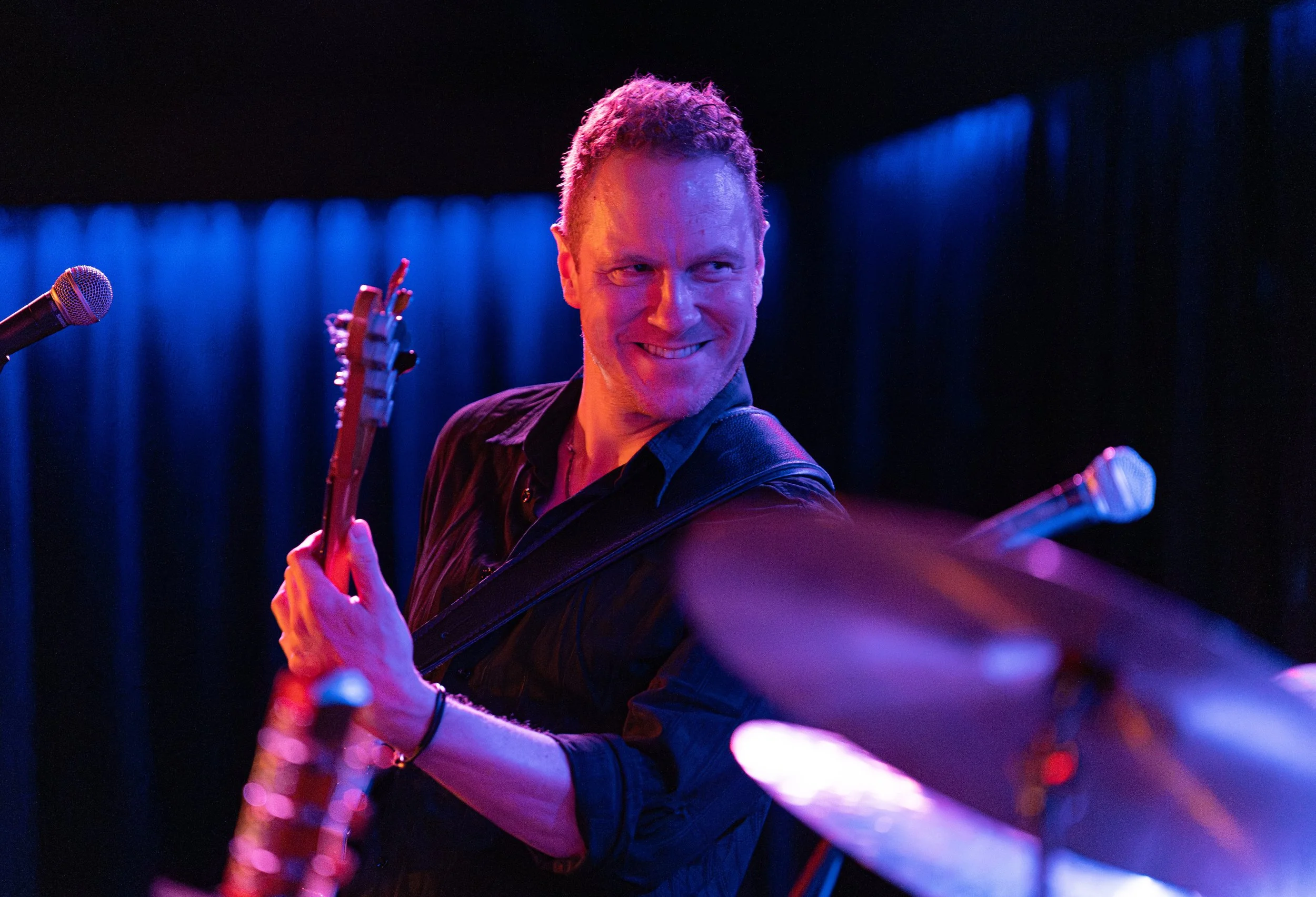  Guitarist James Preston leans back to smile at drummer Abdon Valdez III as they rock out while playing the chords of Reverend Baron’s “Let the Radio Play.” 