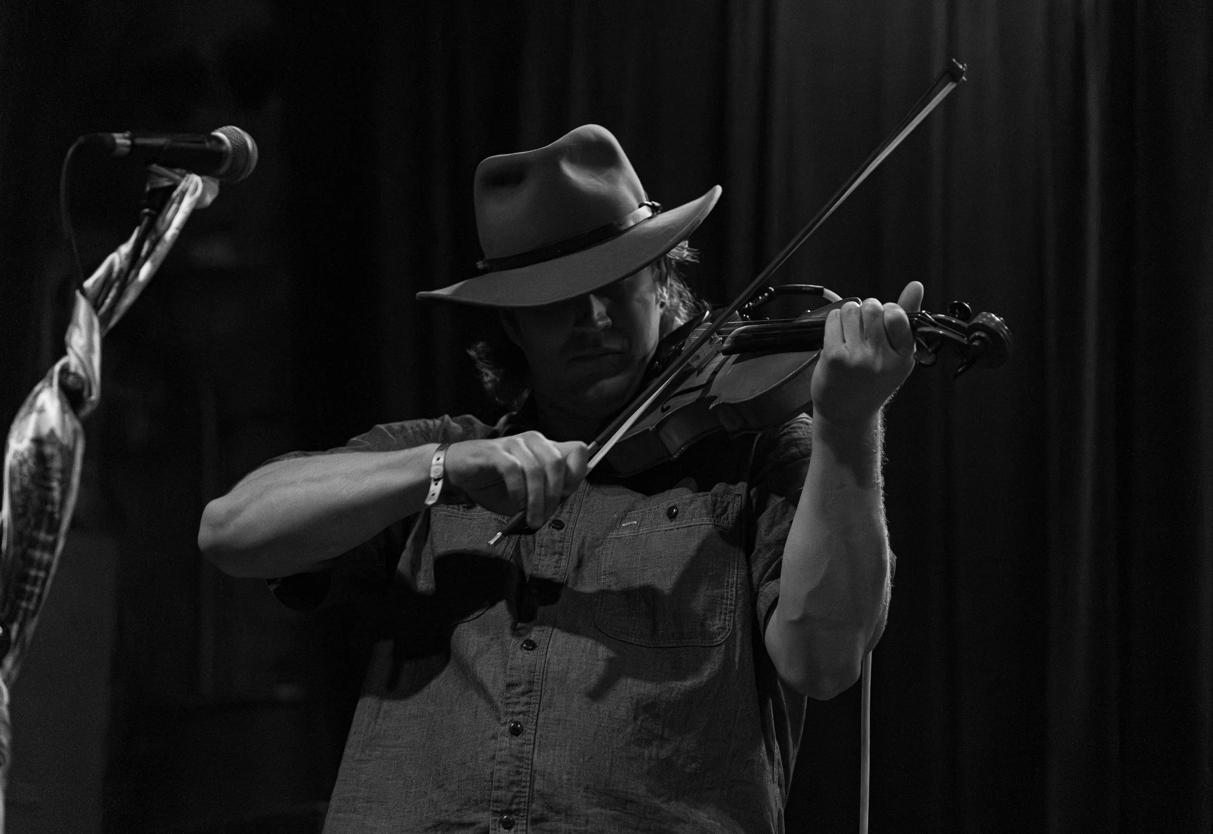  Multi-instrumentalist Payton Andrews plays the fiddle during “Card Games.” 
