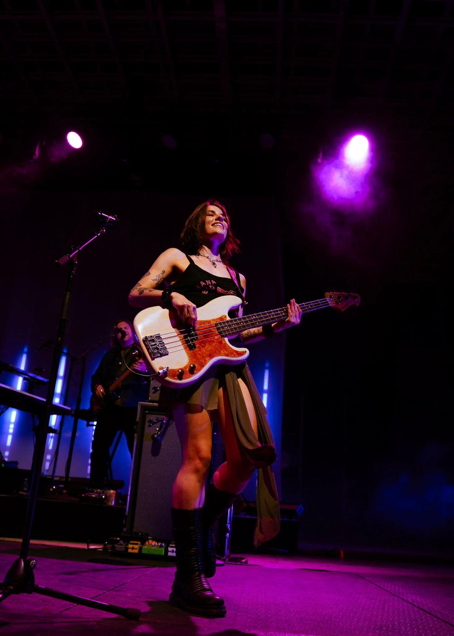  Bassist Maddie Bouton smiles to the crowd while keeping the bassline during “Hide.” 