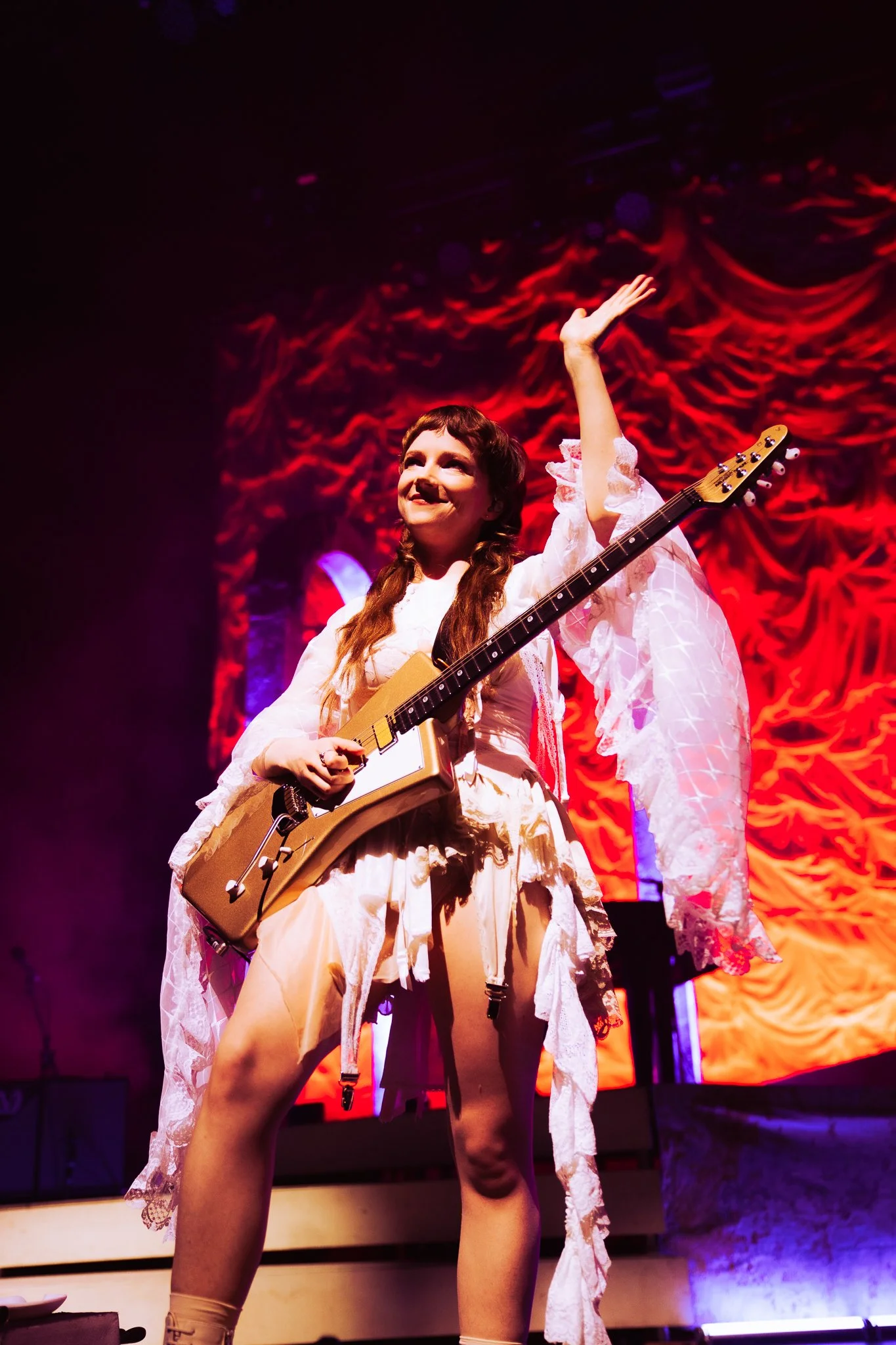  Guitarist Emily Roberts waves to the crowd as Morris introduces Roberts to the audience. 