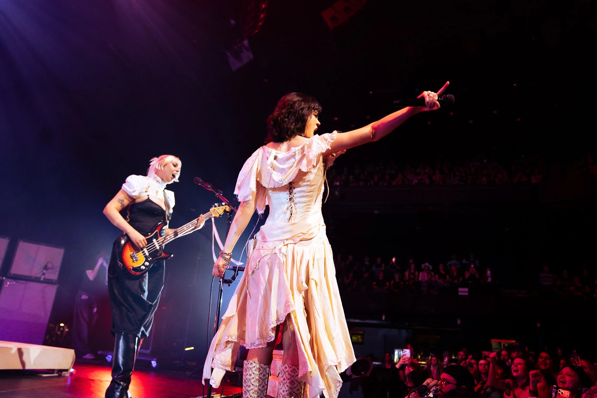  The audience screams the lyrics of “The Feminine Urge” as Morris holds her microphone out to the crowd: “Do you feel like a man when I can’t talk back? / Do you want me or do you want control?” 