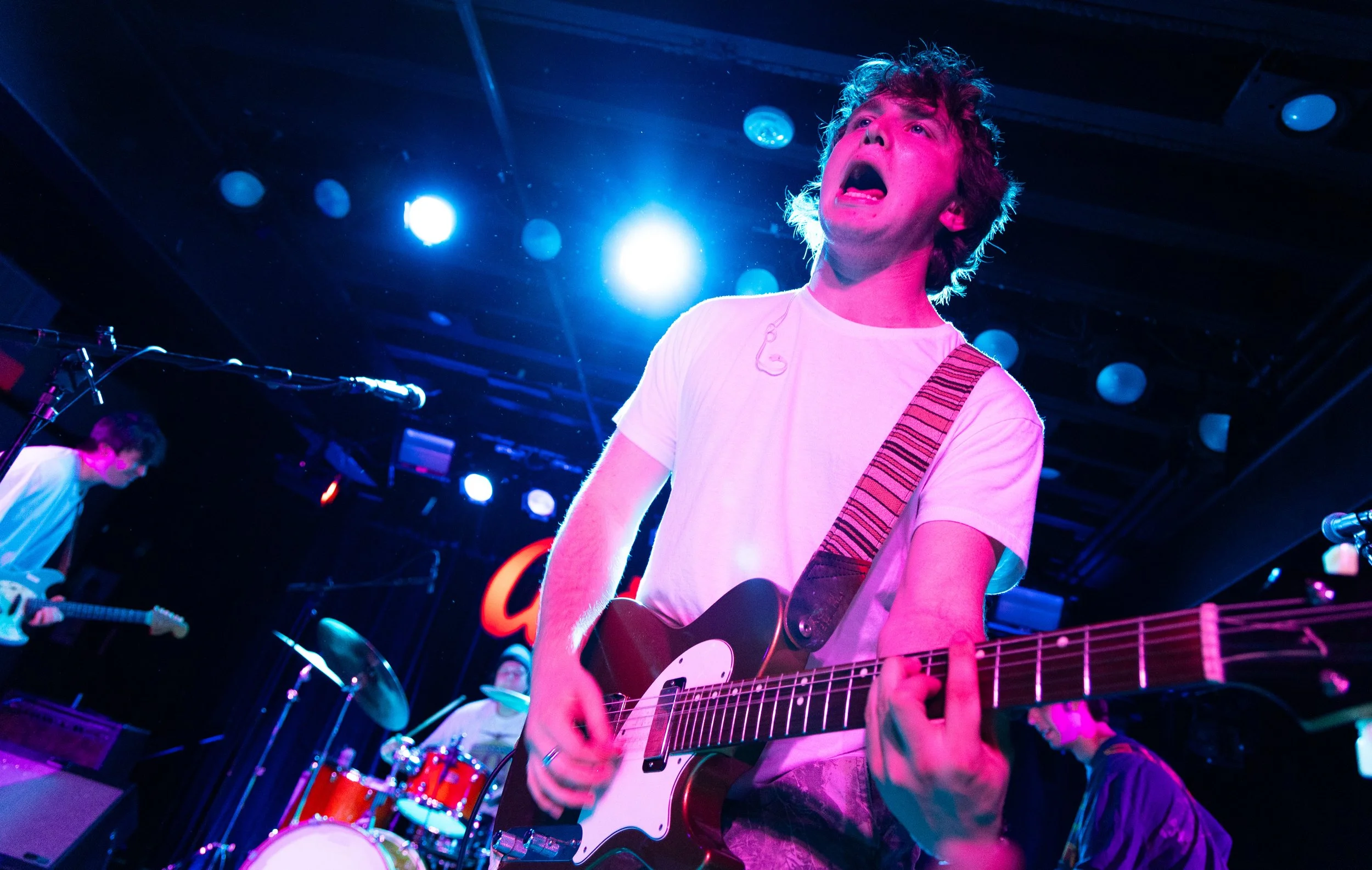  Kelly leans over the crowd while playing the final cords to "Shooting Glances." 