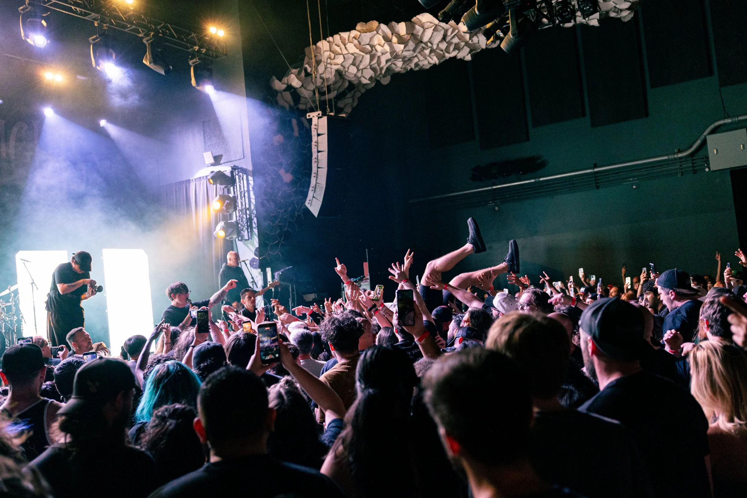  A fan crowd surfs towards Woodruff as he performs on the barricade. 