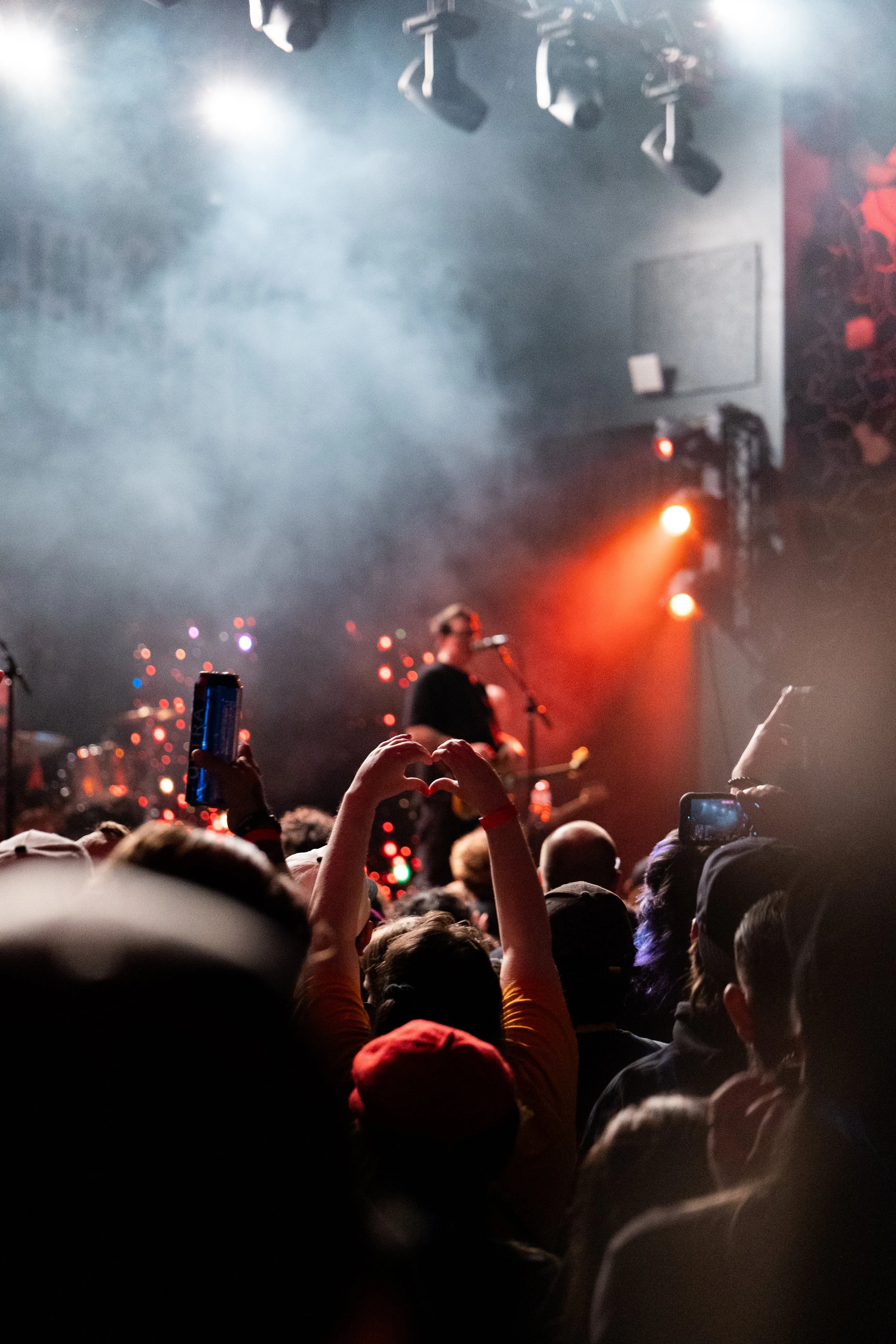  A fan holds up a hand heart while Woodruff gives the audience a parting message. 