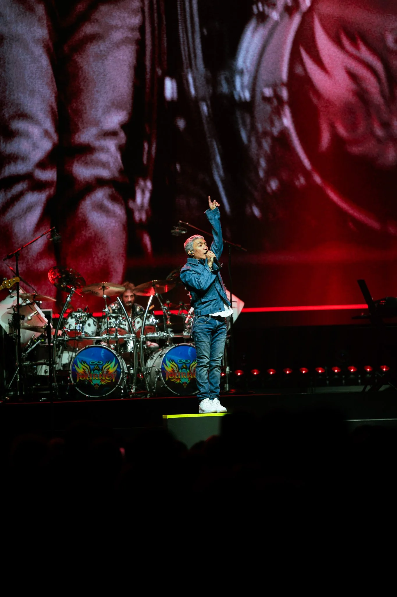  Pineda points to the sky while performing “Ask the Lonely” from Journey’s  Greatest Hits  album. 