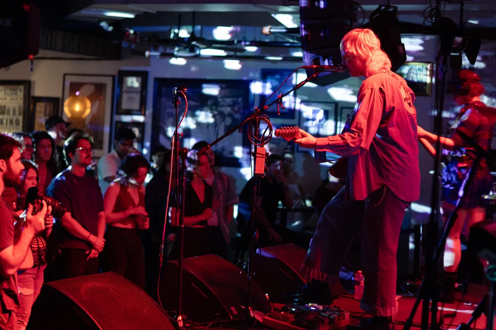  Cooper sings “Changes” to the crowd in red mood lighting. 