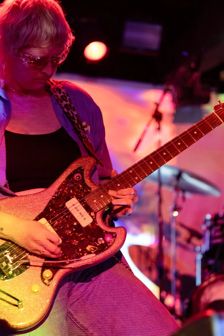  Cooper plays guitar on her knees during the instrumental portion of "Changes.” 
