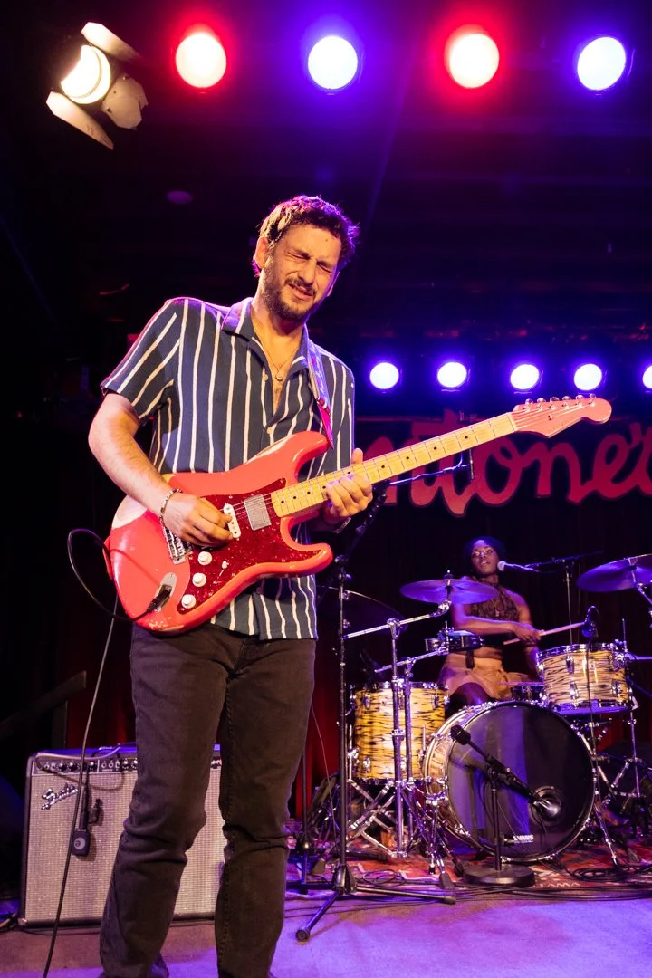  Guitarist Ori Naftaly plays the dynamic instrumental break of “So Much Love.” 