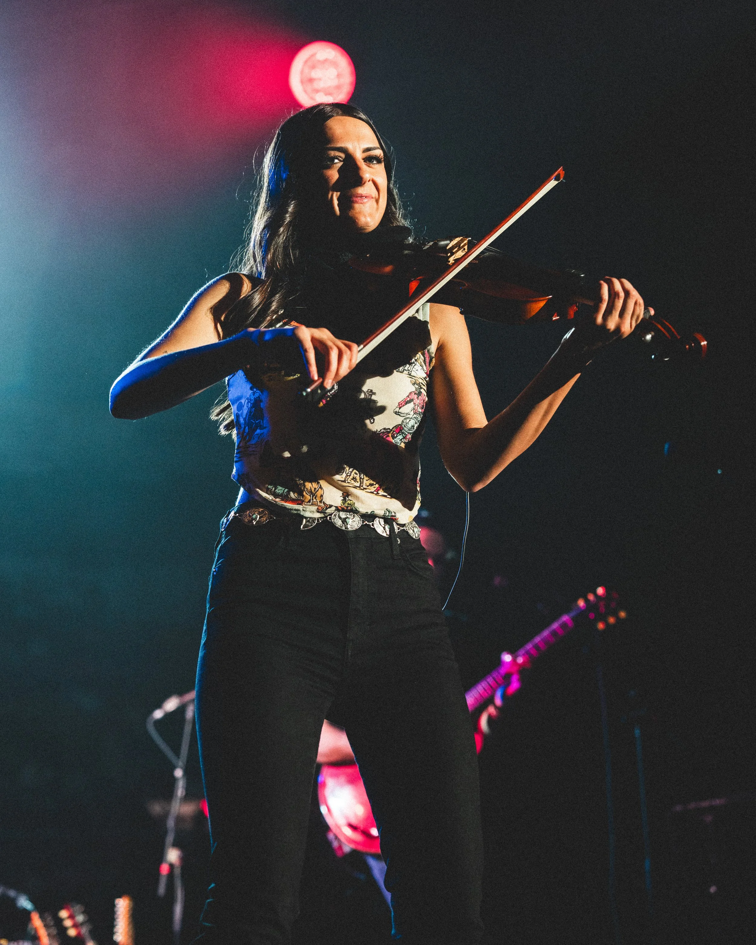  Kenzie Miracle plays fiddle in support of Wyatt Flores. 