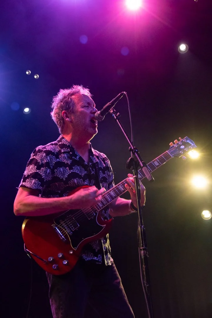  Zuniga plays the guitar and sings during power pop song “Sooner or Later.” 