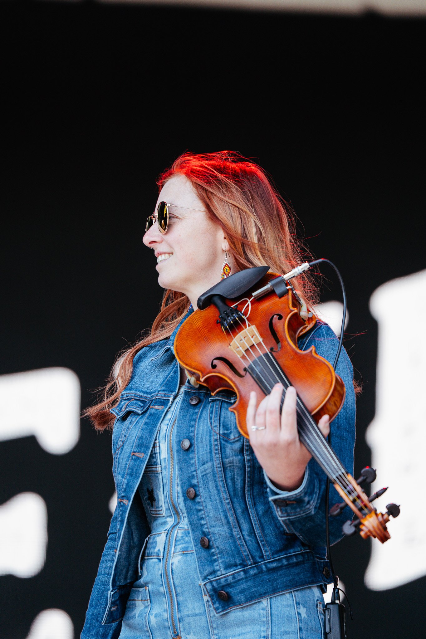  Bluegrass band The Creekers opens the festival at the Pony Up stage with banjo, acoustic guitar, and fiddle instrumentals. 