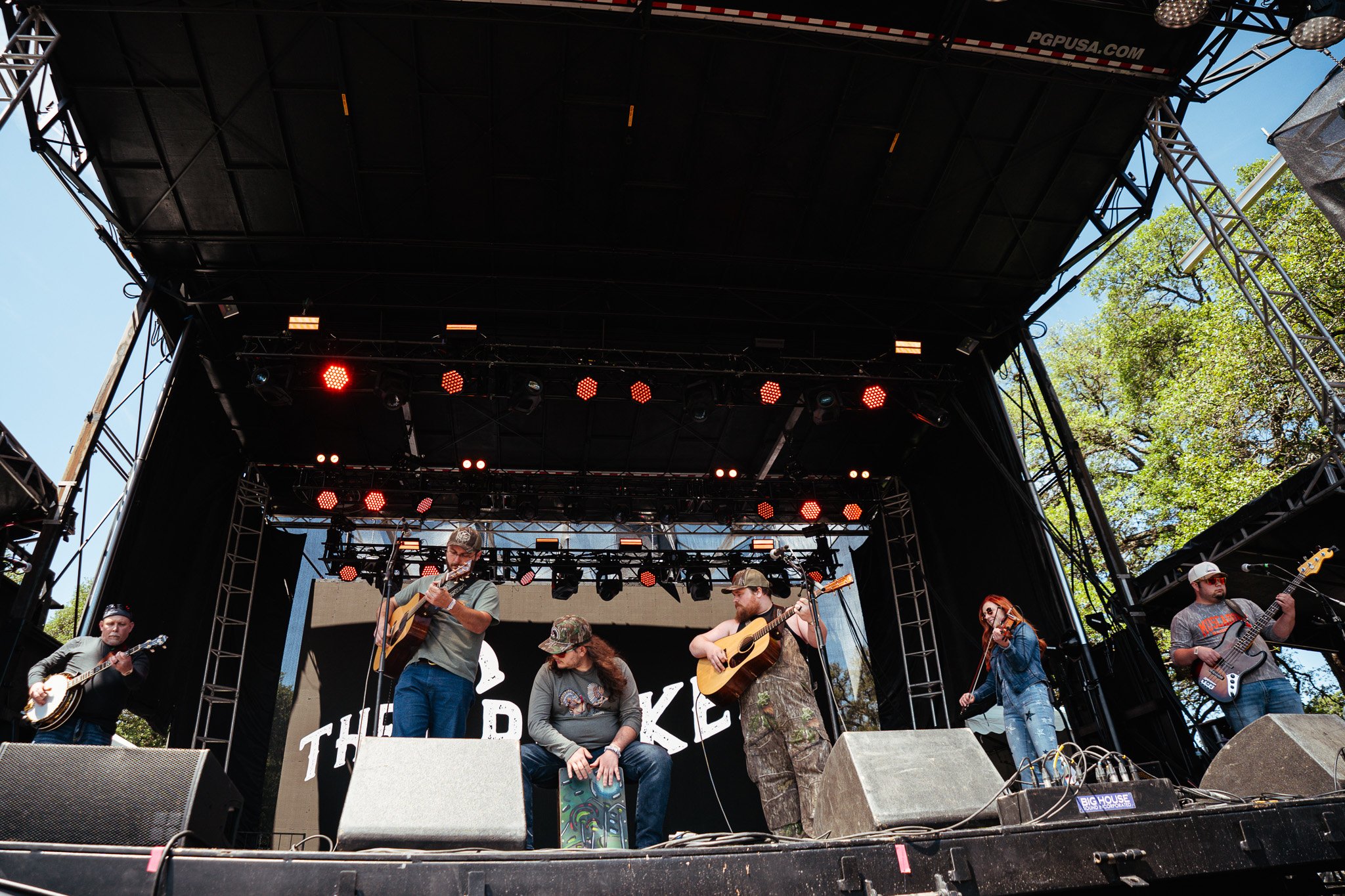  Bluegrass band The Creekers opens the festival at the Pony Up stage with banjo, acoustic guitar, and fiddle instrumentals. 