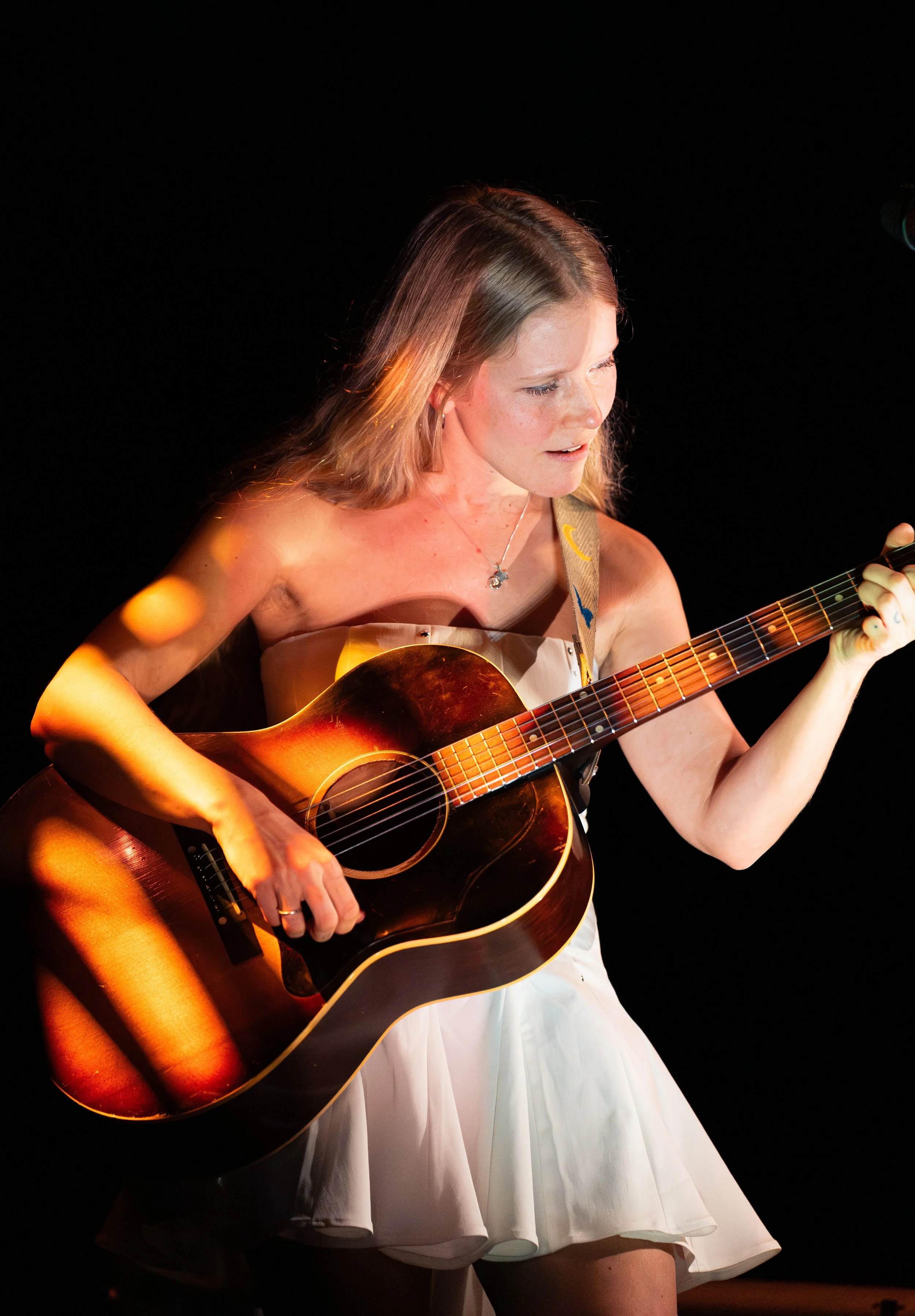  Lou plays the chords of “Darling” while she sings the hopeful lyrics: “I hid you in my heart / Until I couldn’t anymore / But that’s just how it works / When love is on your side.” 