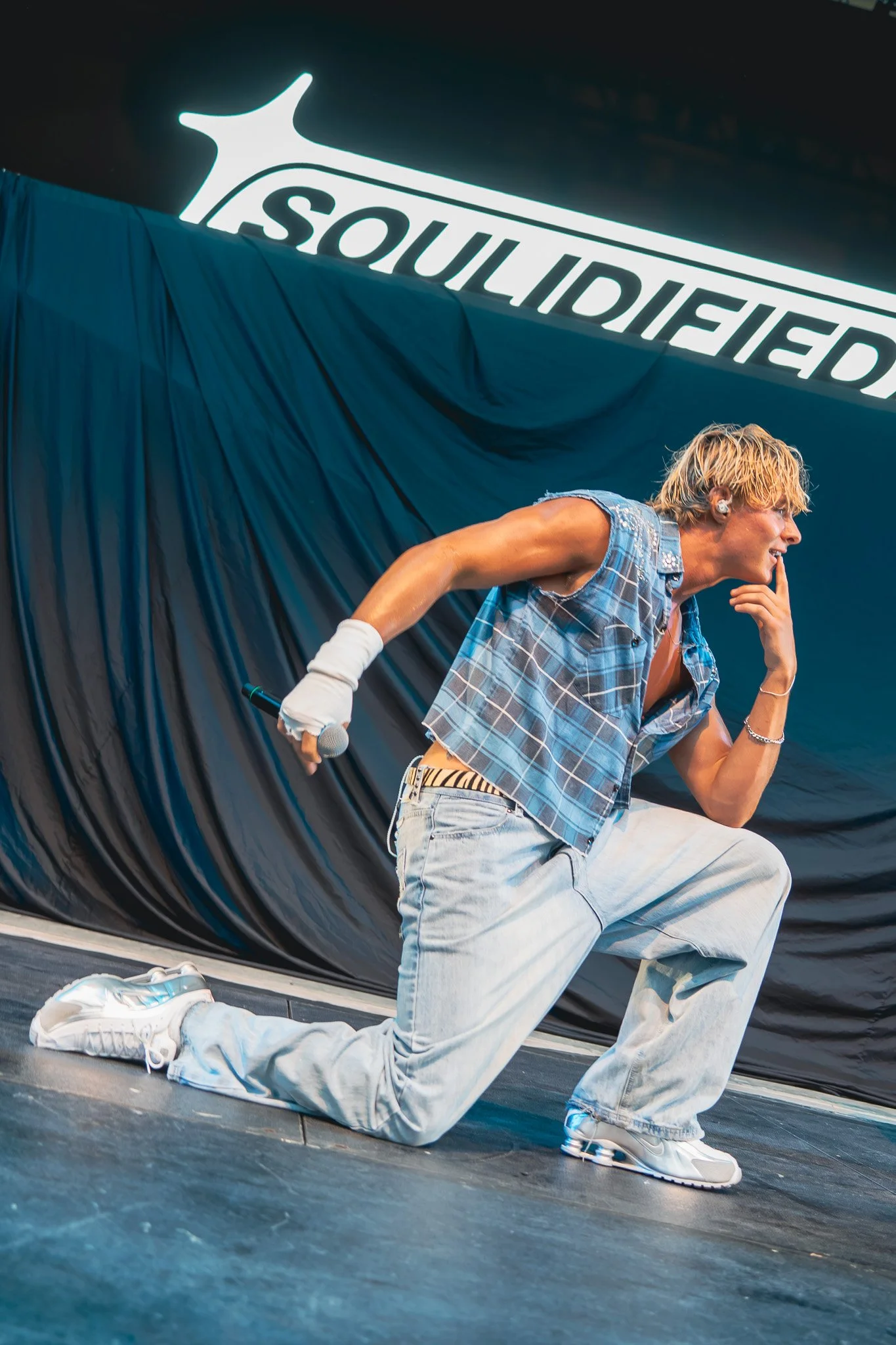  Landon Boyce bends down during the performance of “What’s Your Name” a&nbsp; R&amp;B-pop single. 