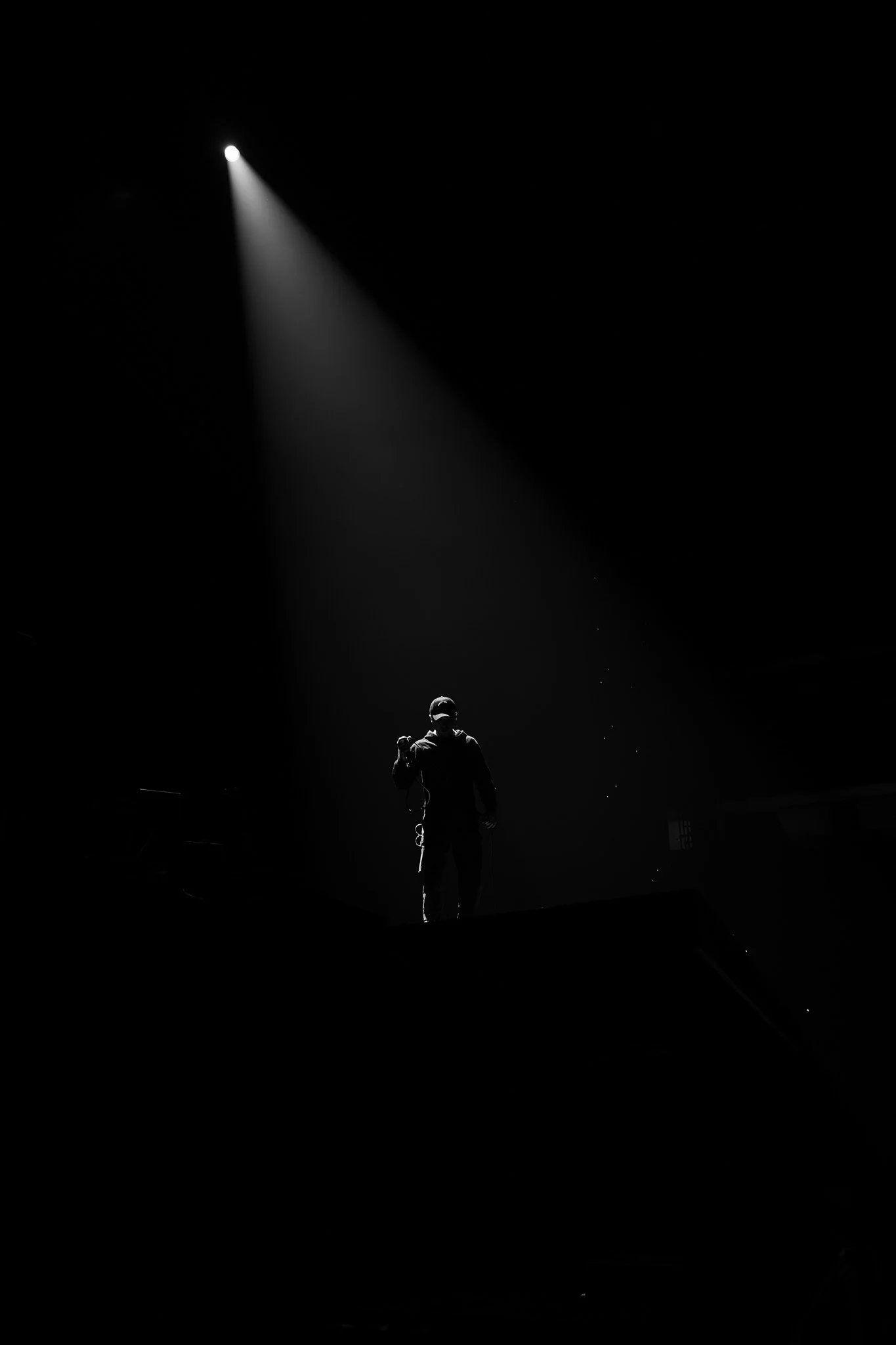  Corbin stands in the spotlight during his performance of “Carbon Monoxide” from his 2025 post-punk album  Crisis Kid . 