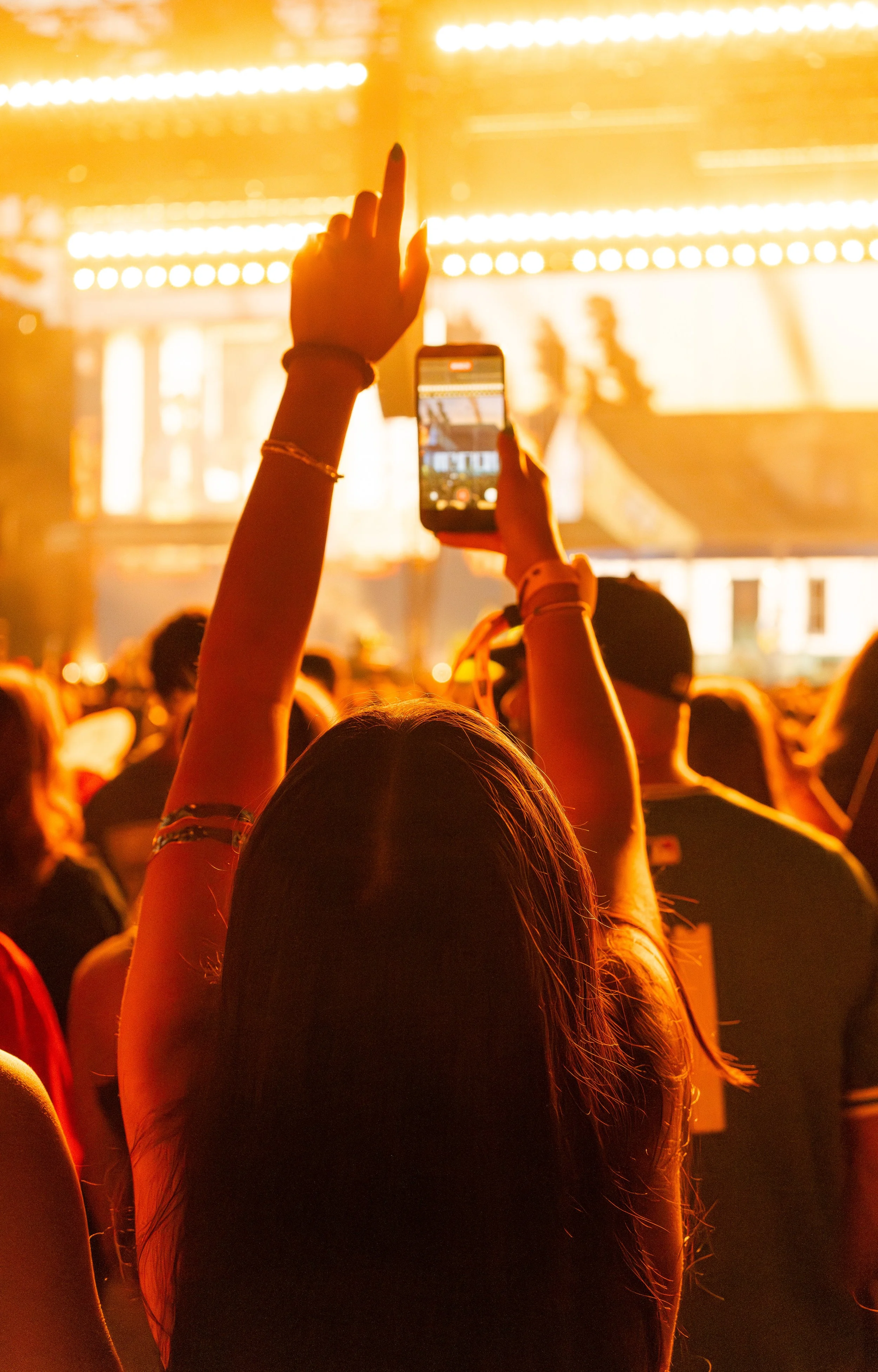  A fan reaches up her hand while singing along to the chorus of “Doors.” 